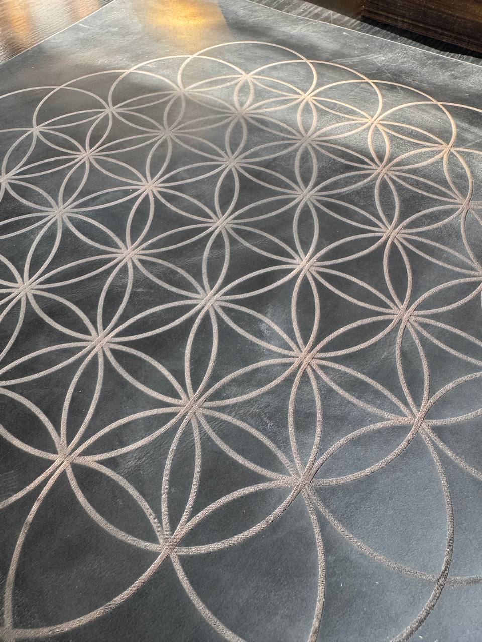 a close-up view of a black and white geometric pattern on a surface, resembling a honeycomb or a circular design.