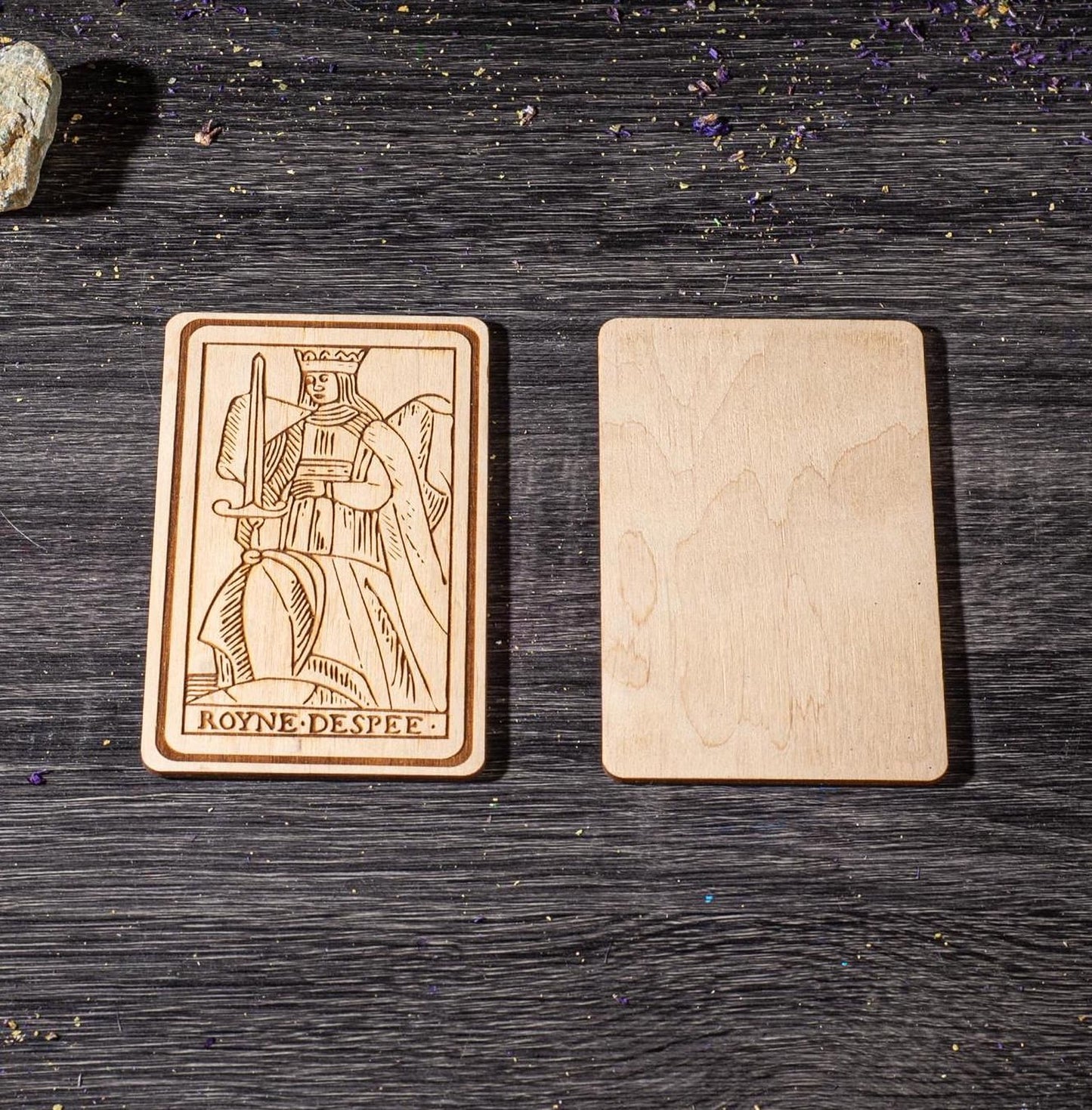 a wooden card with an embossed design, placed on a wooden surface.