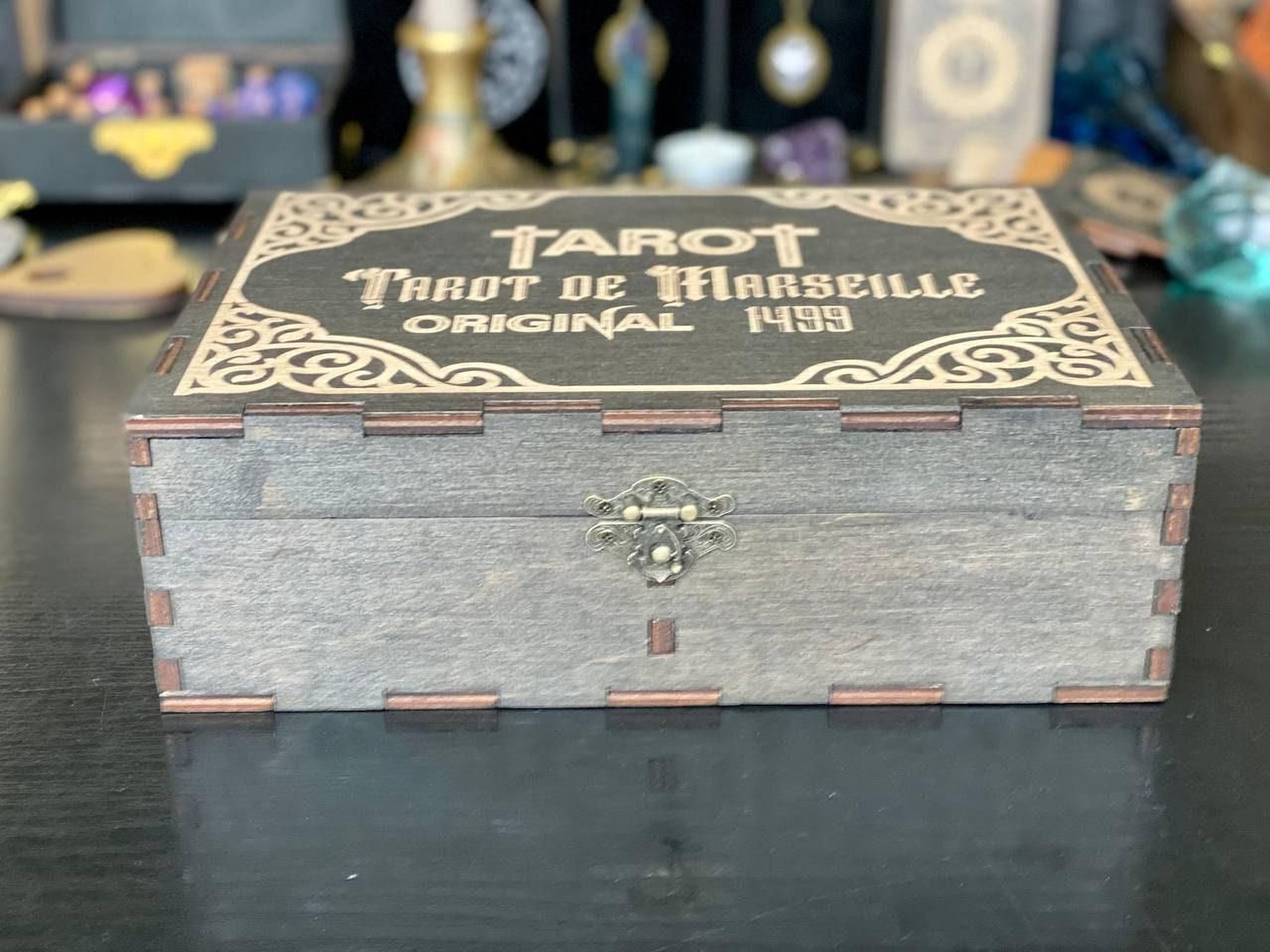 A wooden box with a decorative border and a metal clasp, labeled "Trot de Marseille" and "Original 4999".