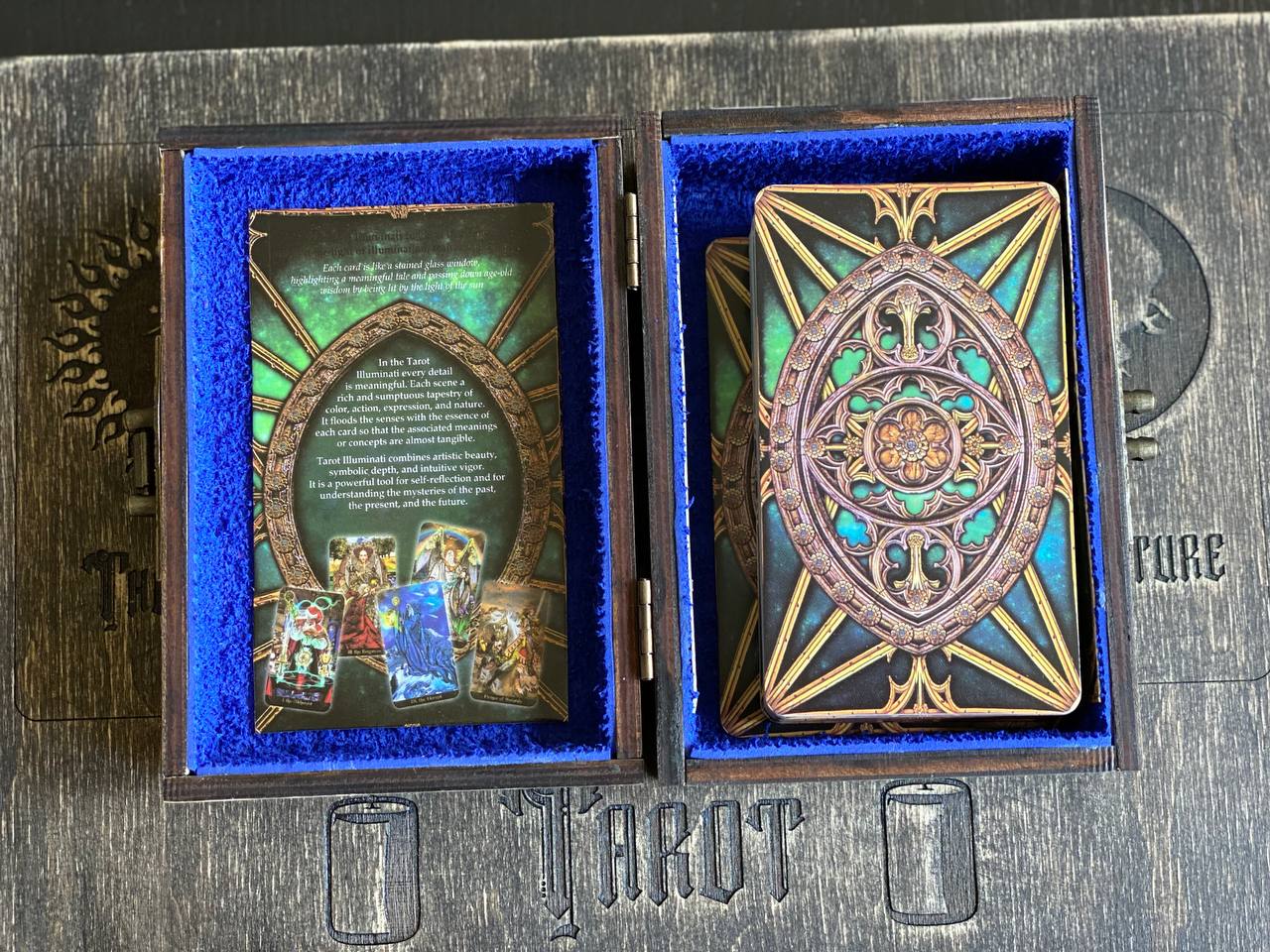 a wooden box with a blue interior, containing a deck of tarot cards. The cards are arranged in an open state, revealing their intricate designs and illustrations.