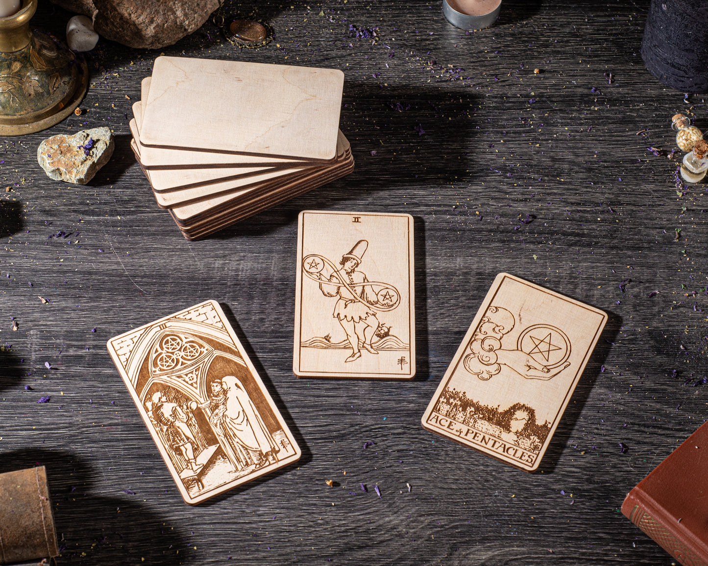 three wooden tarot cards with intricate designs, placed on a wooden surface.
