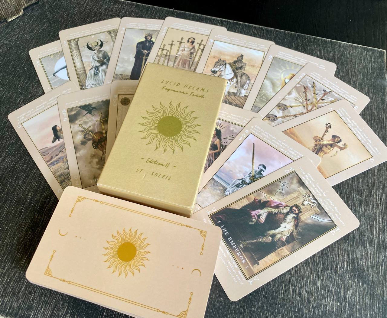 a collection of tarot cards and a box, with the box prominently displaying the text "LUCID REFERS BEGINNINGS ST-SIEBIEL".