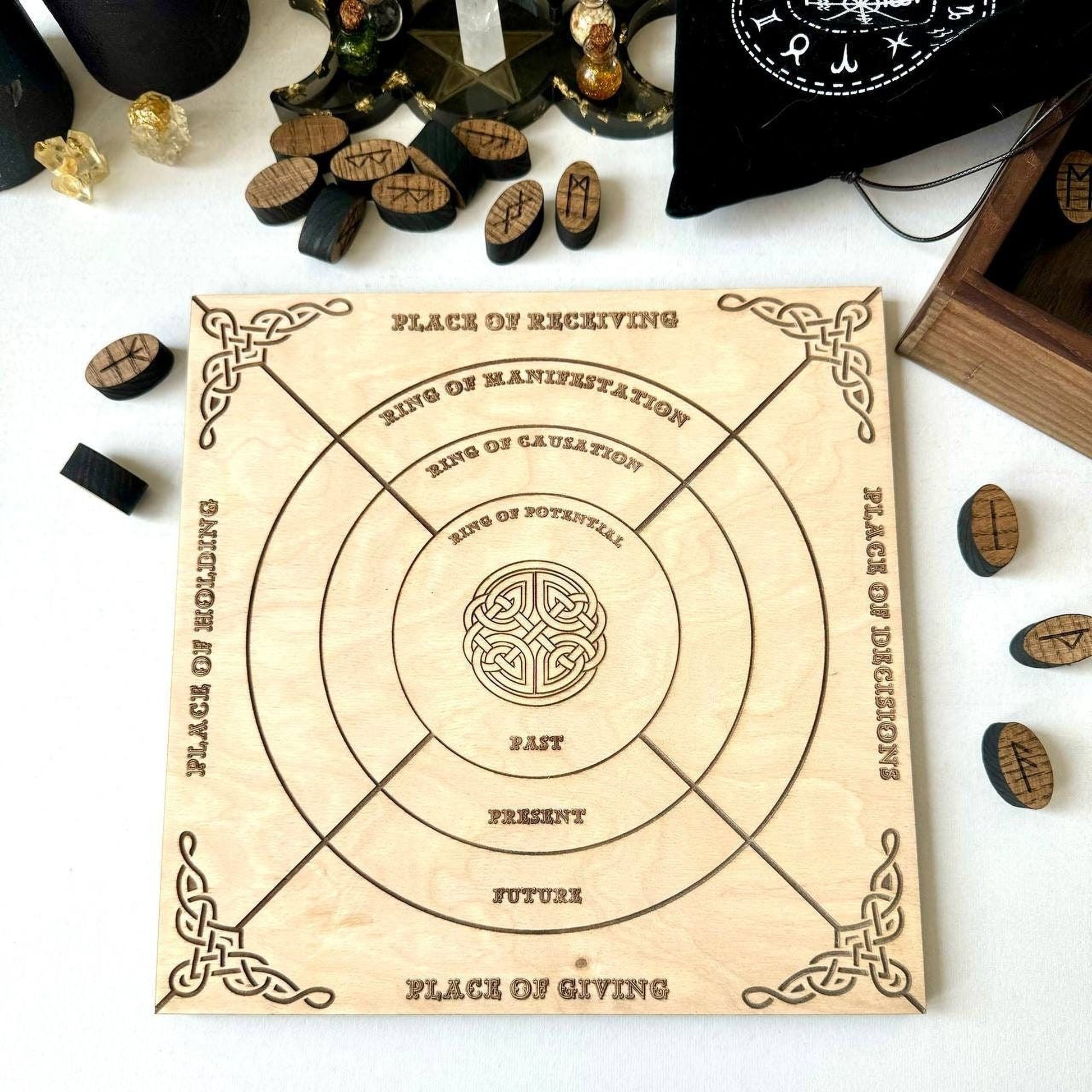 a wooden board game with various carved elements and a central design, surrounded by scattered wooden pieces and other items.