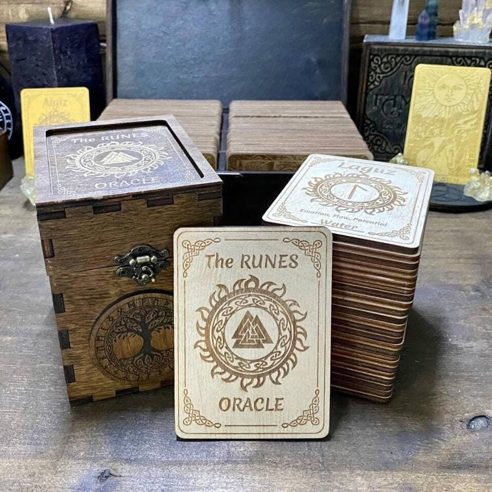 a collection of wooden Oracle cards, including a wooden box and several Oracle cards stacked on a wooden surface.