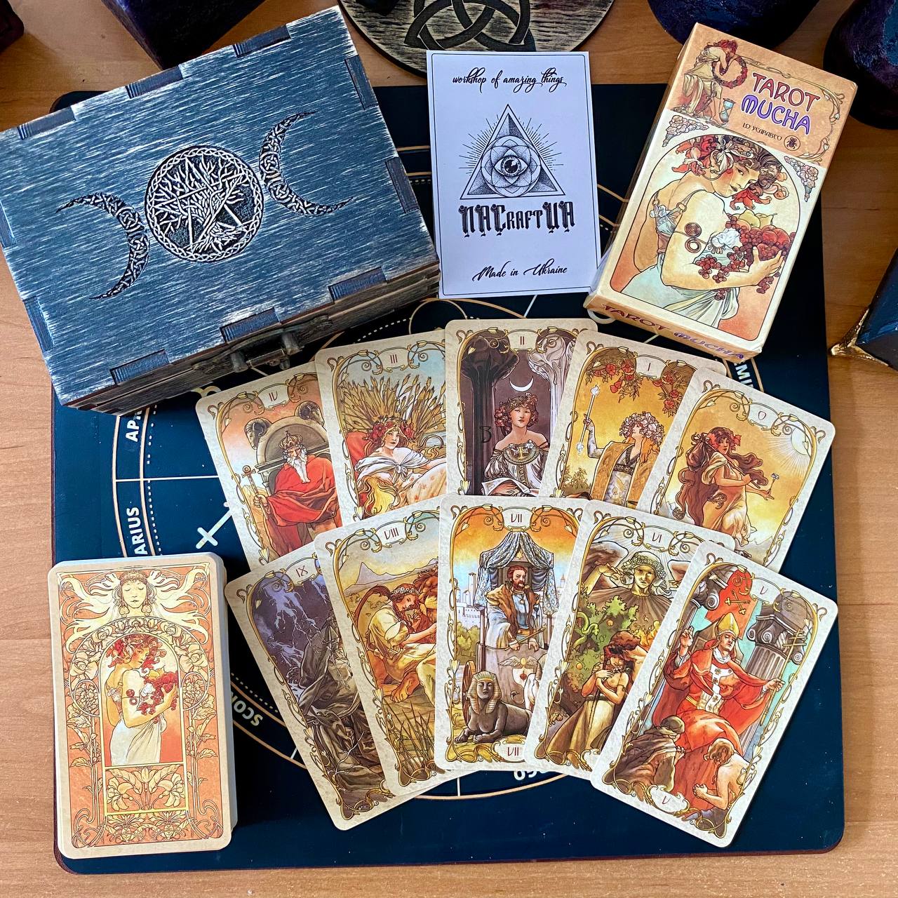 a collection of tarot cards and a wooden box, possibly containing additional items related to tarot or fortune-telling.