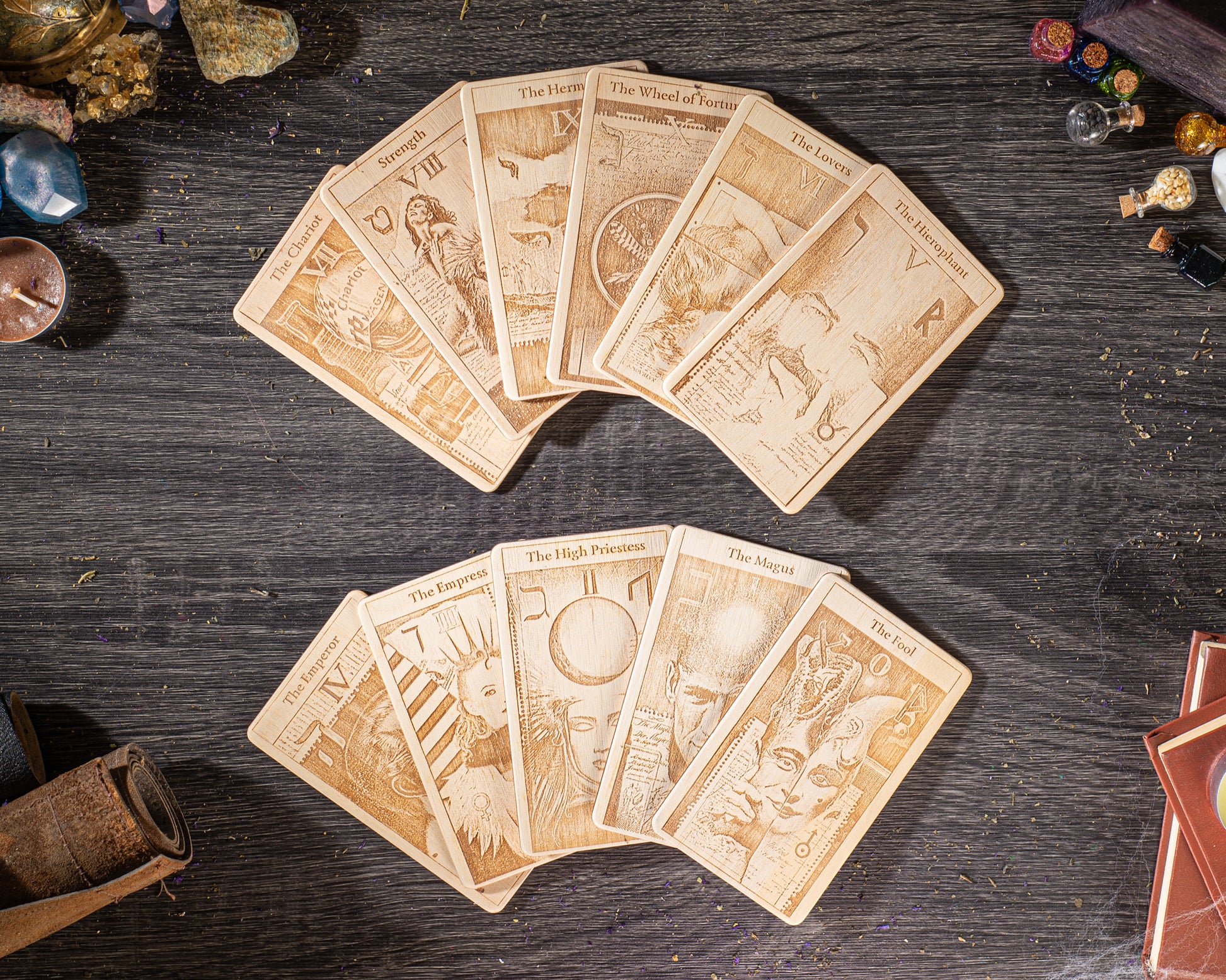 A collection of tarot cards spread out on a wooden surface, with various illustrations and text on the cards.