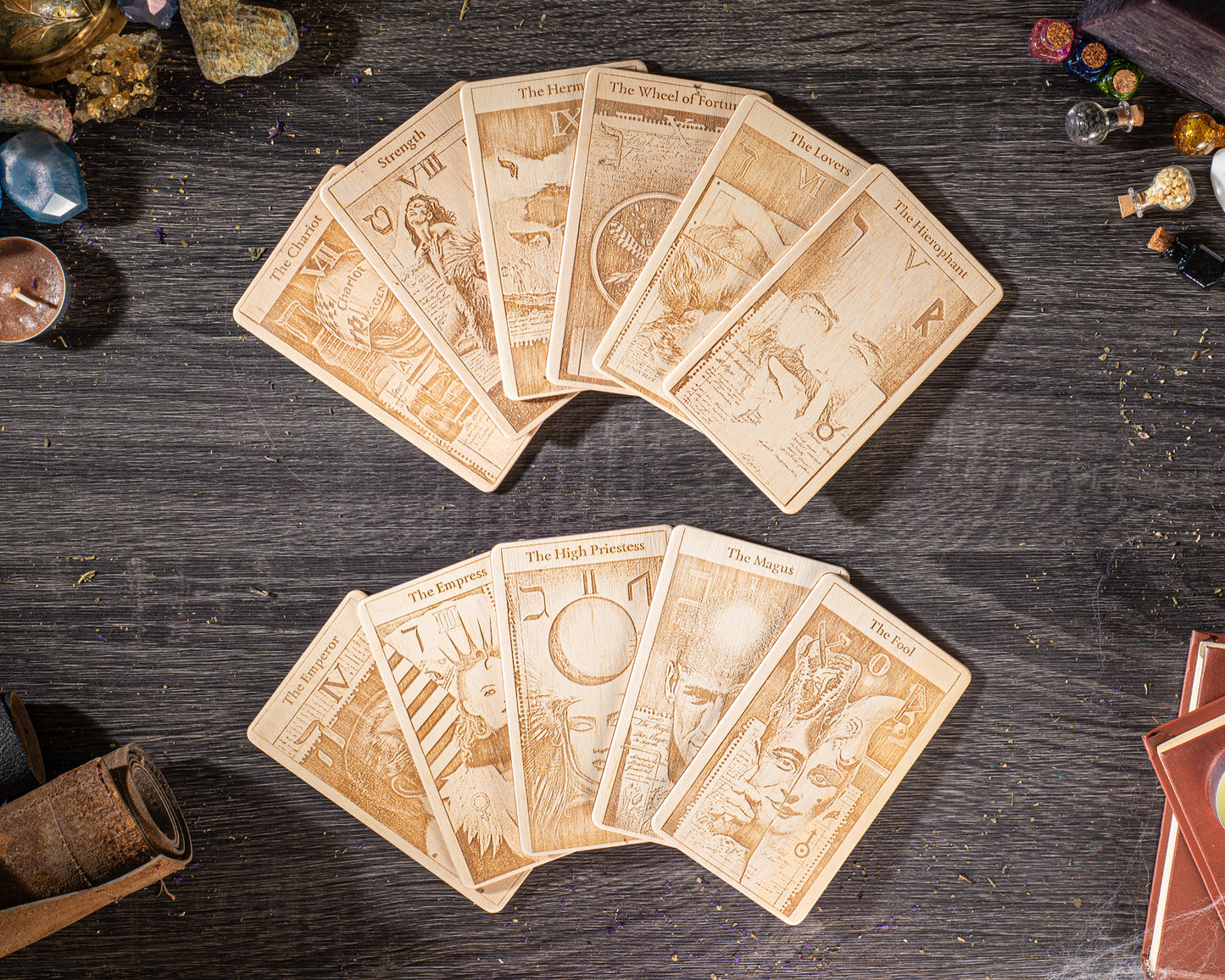 A collection of tarot cards spread out on a wooden surface, with various illustrations and text on the cards.