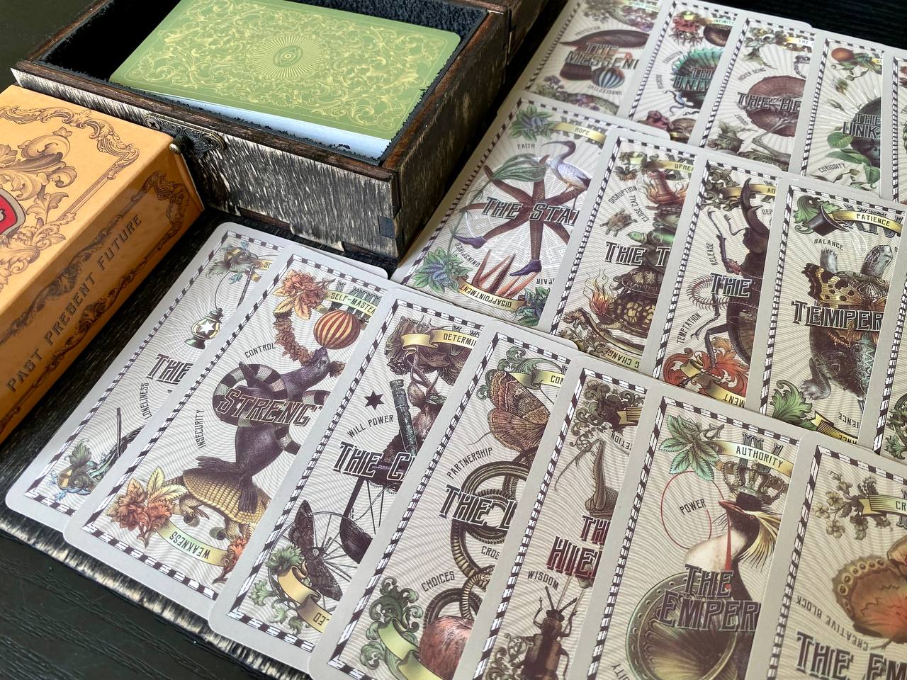 a collection of playing cards with various illustrations and text, arranged on a surface.