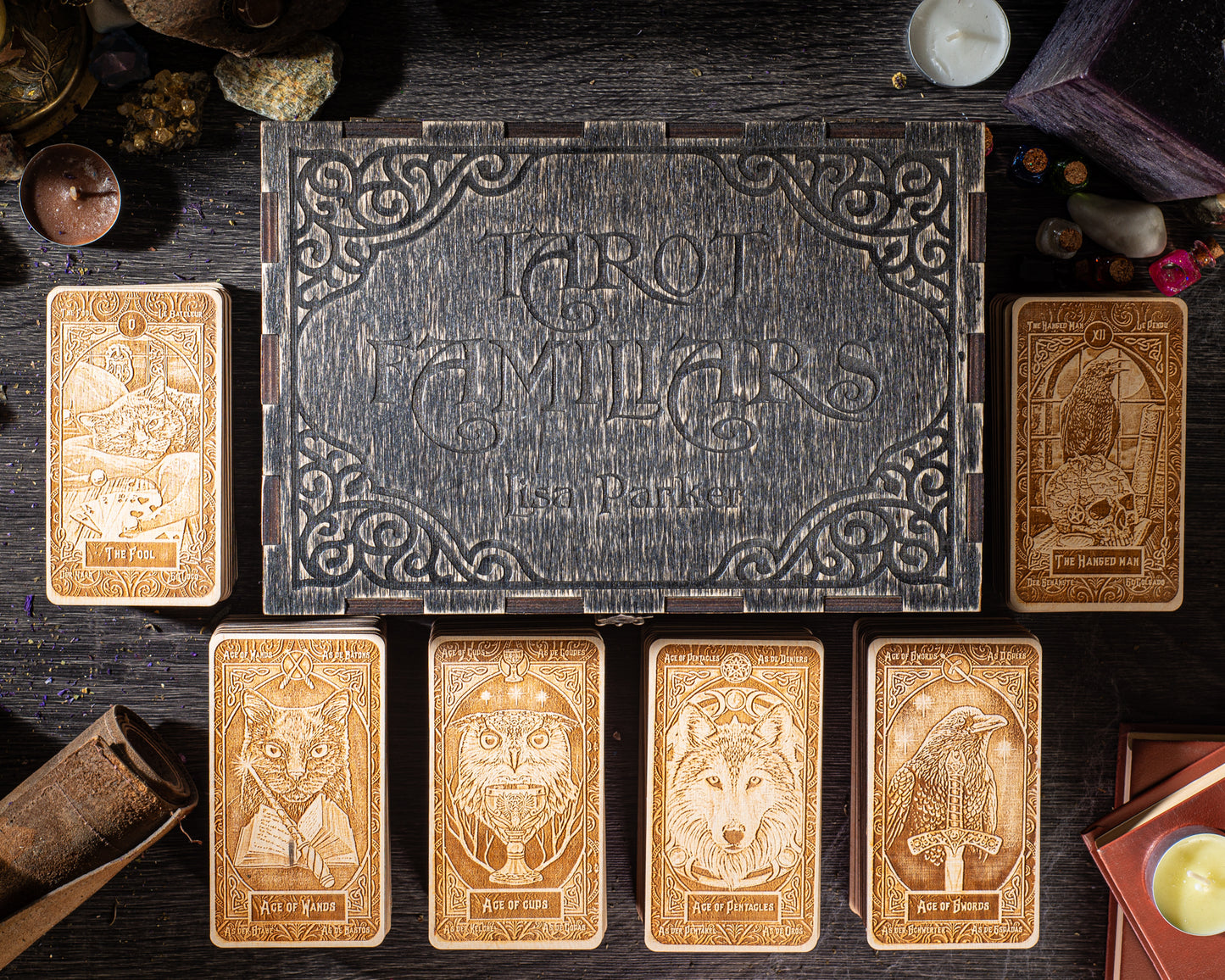 a collection of six tarot cards arranged on a wooden surface, with a wooden box in the background.