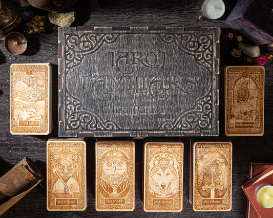a collection of six tarot cards arranged on a wooden surface, with a wooden box in the background.