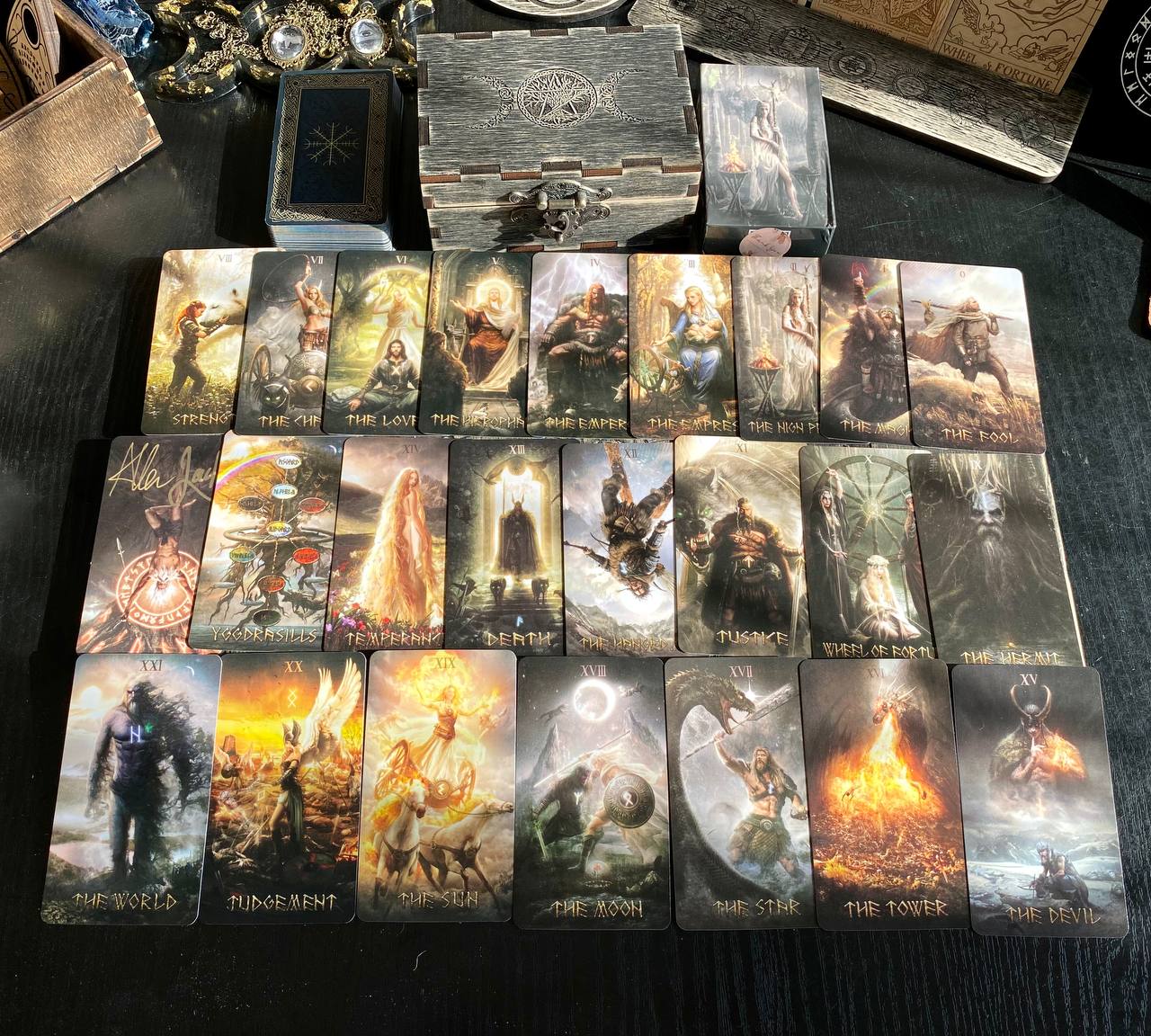a collection of tarot cards arranged on a table, with various fantasy-themed illustrations and text.