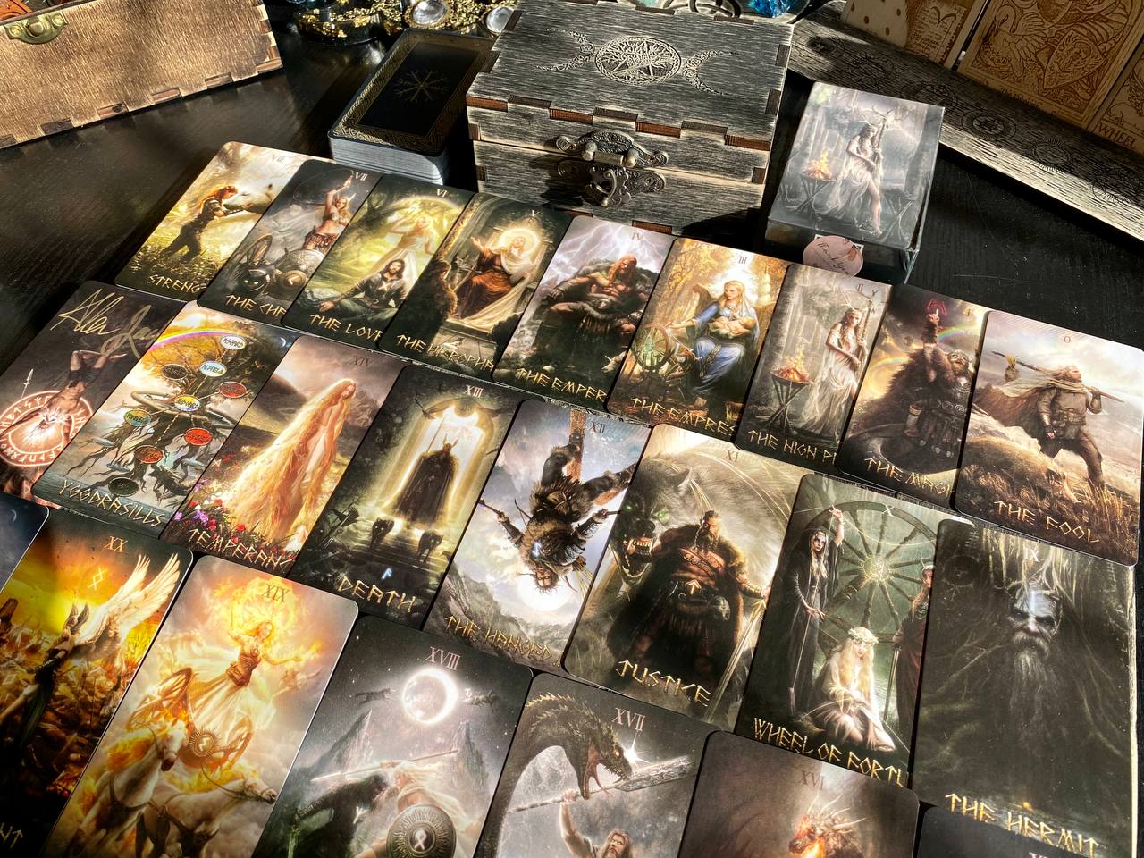 a collection of tarot cards arranged on a table, with various fantasy-themed illustrations and text.
