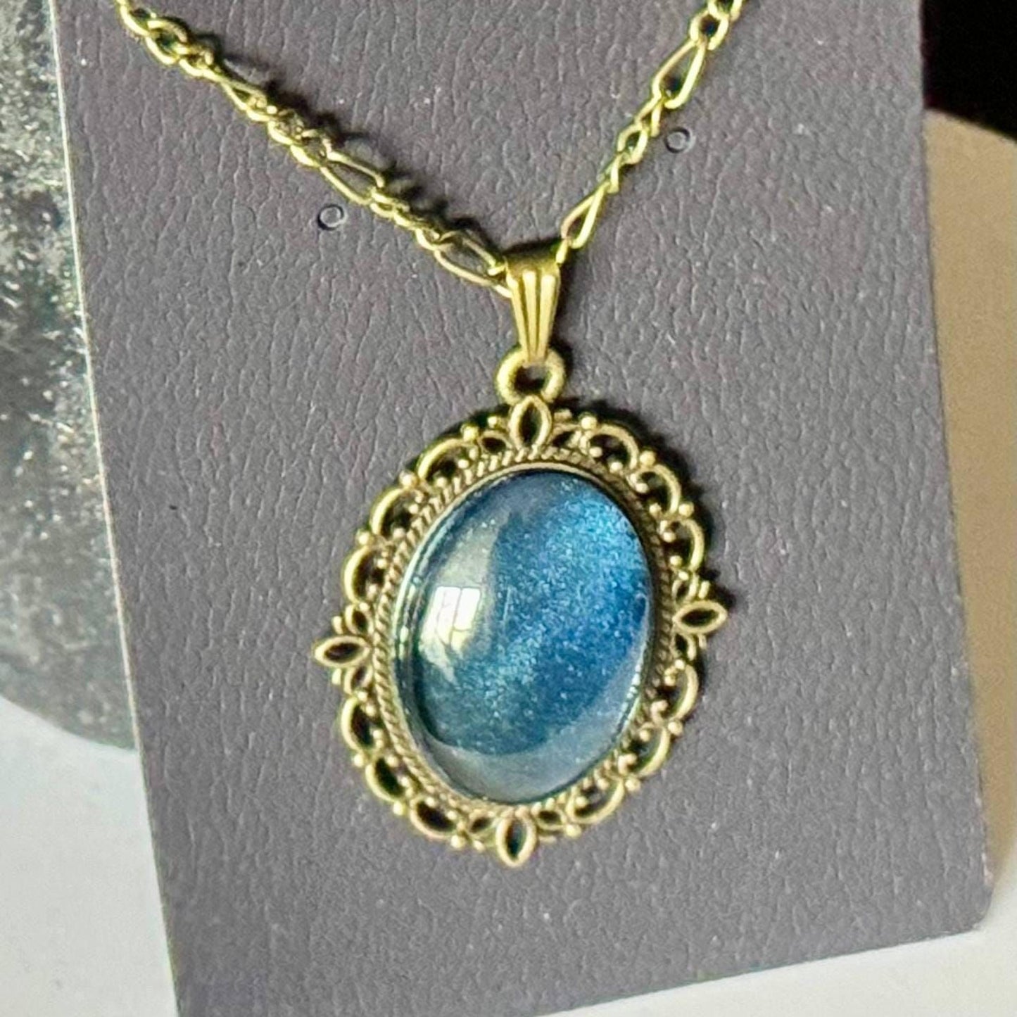 A necklace with a large, blue gemstone pendant, which appears to be a piece of jewelry.