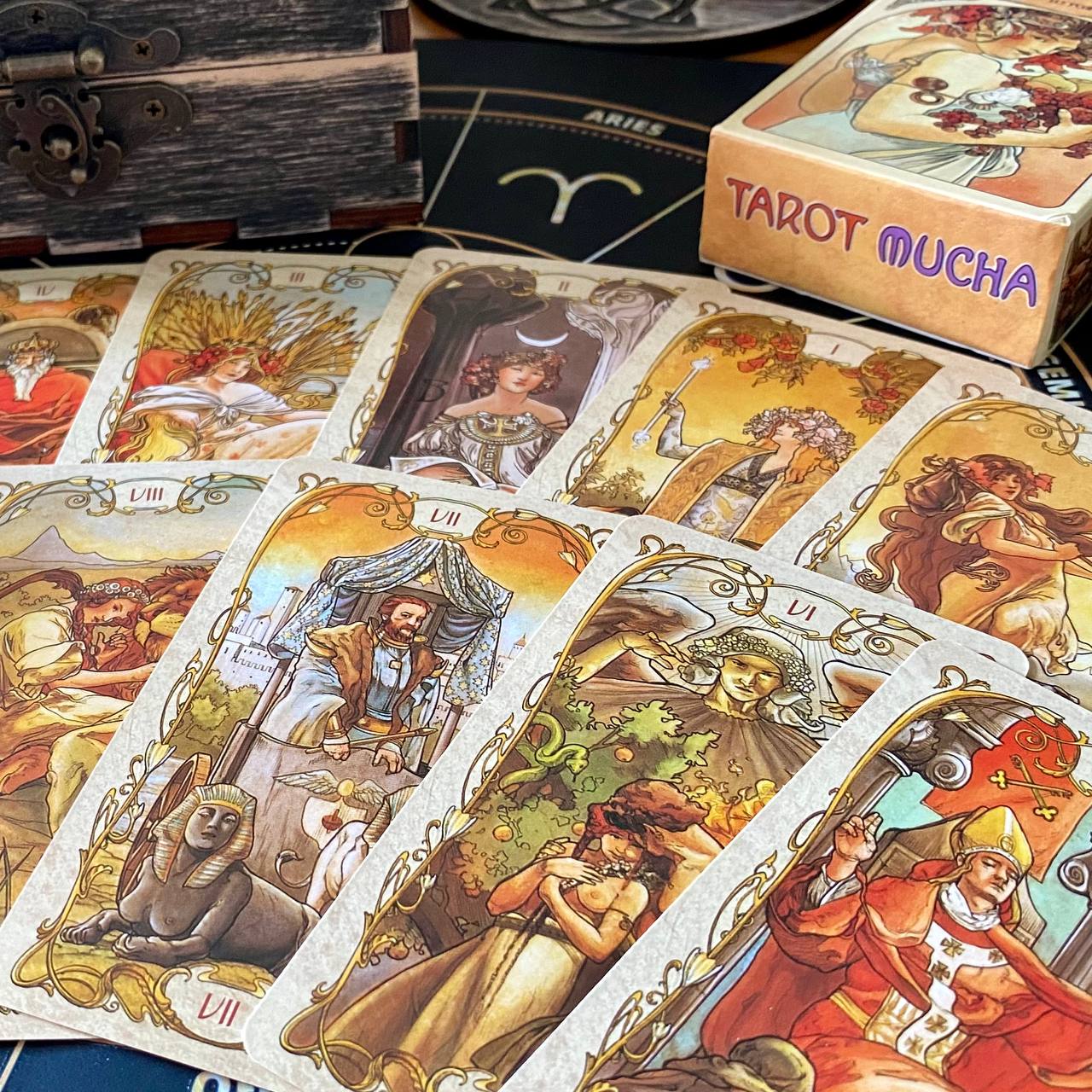 a collection of tarot cards with intricate artwork, arranged on a surface.