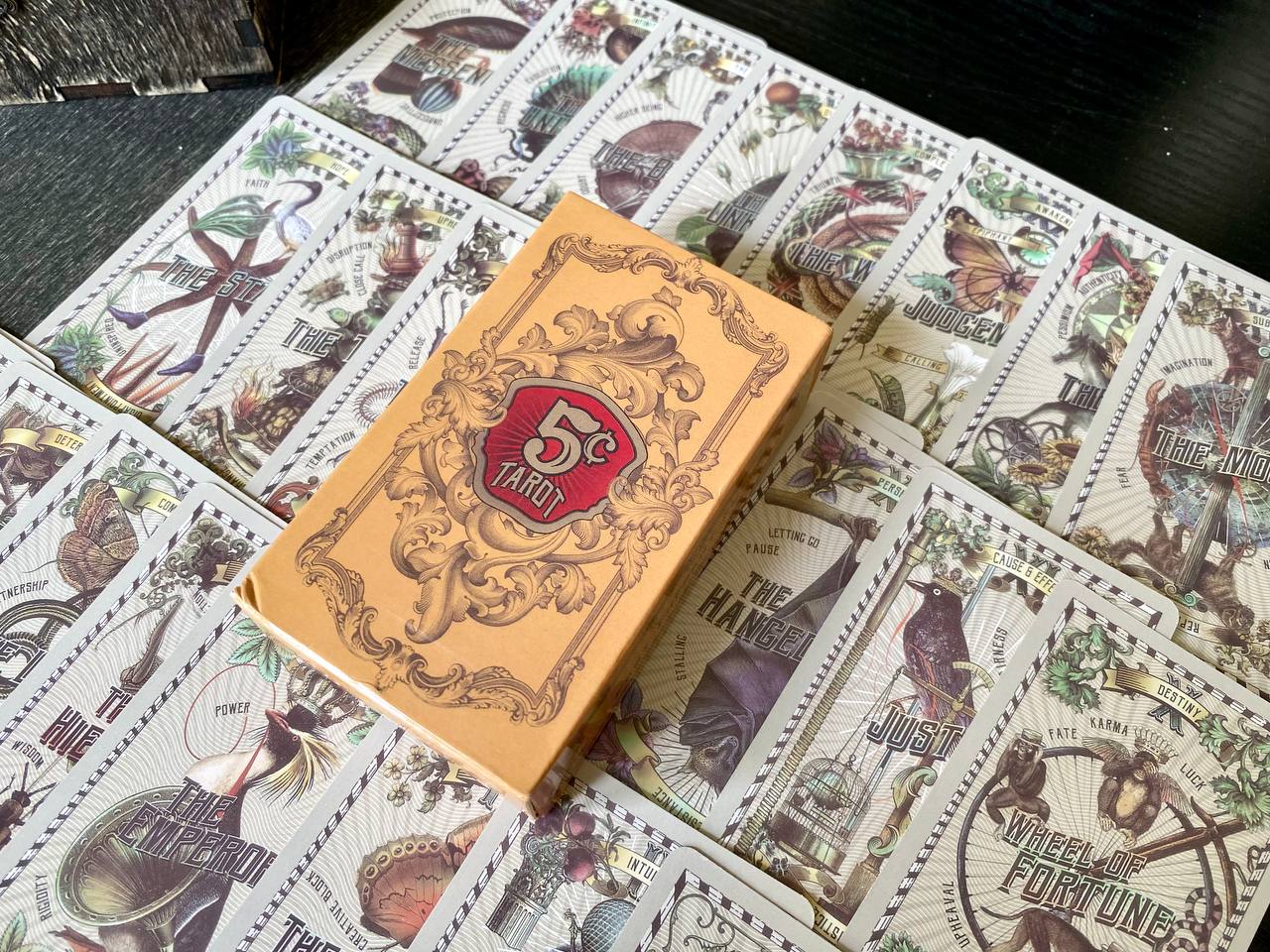 a collection of tarot cards with various illustrations and text, including the number 5 and the words "Fortunes" and "Wheel of Fortune".