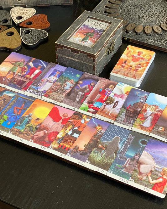 a collection of tarot cards and other objects arranged on a table.