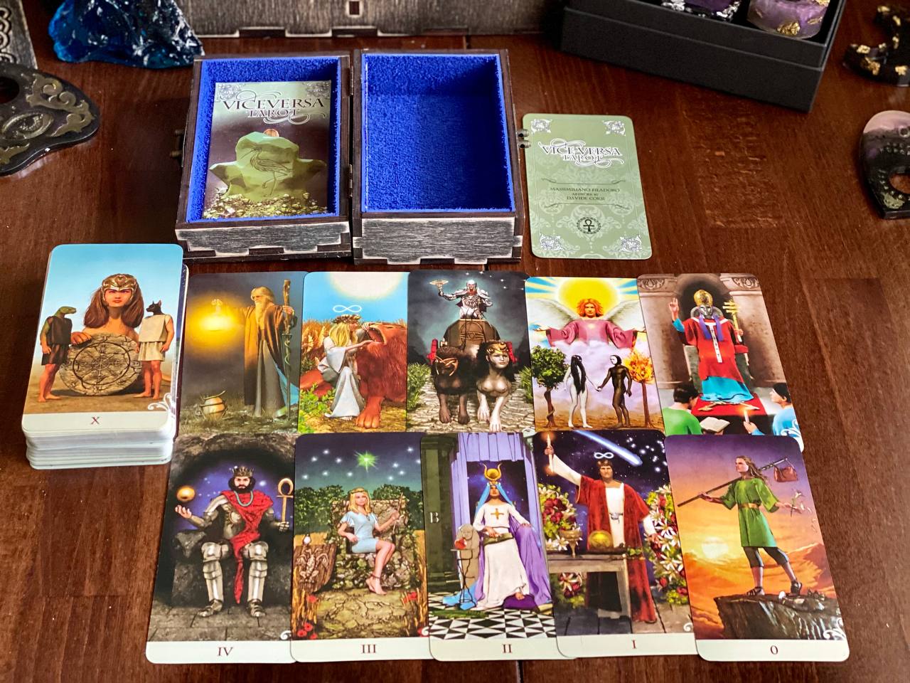 a tarot deck with various cards featuring different scenes and characters, including a central card with a woman and a man, a card with a castle, and a card with a man on a horse.