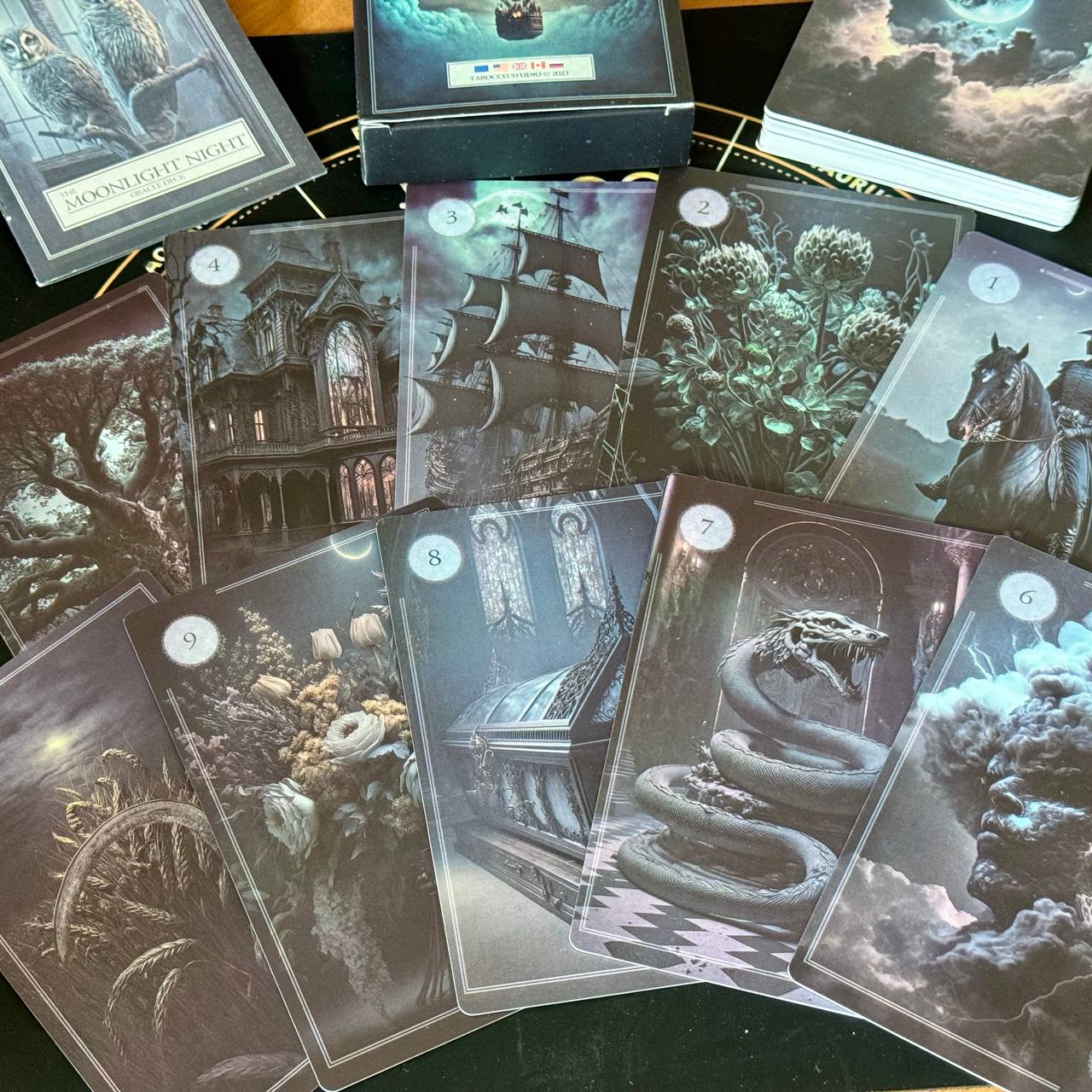 a collection of tarot cards with various fantastical and mystical scenes, including a castle, a snake, and other symbolic imagery.