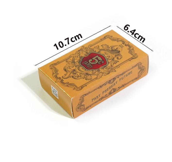 a rectangular box with a gold-colored exterior and a red and black logo on it. The box is placed on a white surface, and there are measurements drawn above and below it.