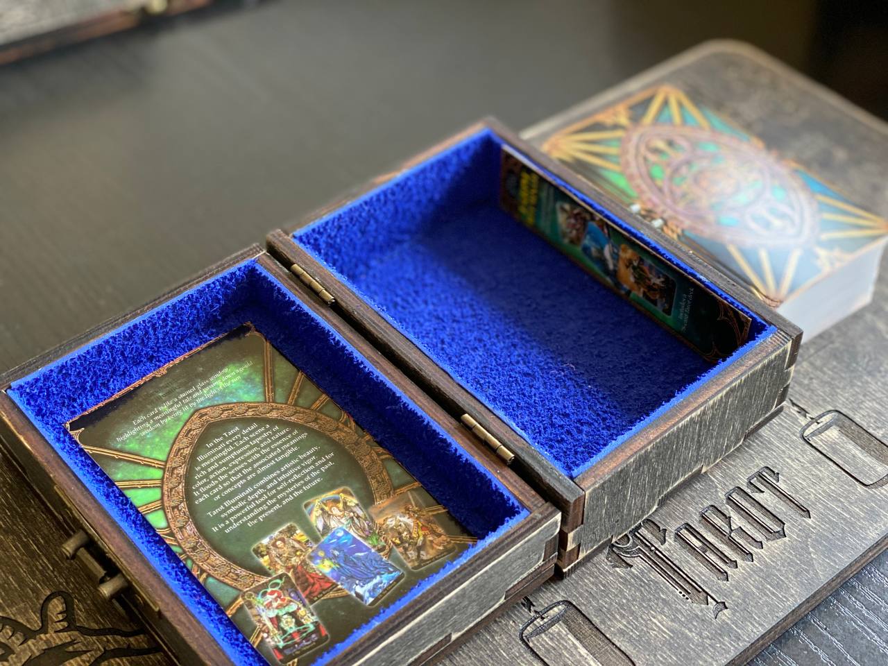 an open wooden box with a blue interior, displaying a card or card-like item inside.