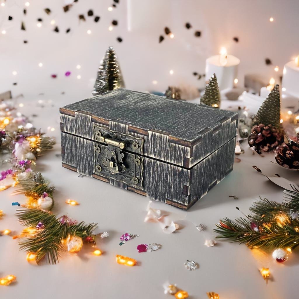 A wooden box with a metal clasp sits on a table surrounded by Christmas decorations, including pine cones, tinsel, and colorful ornaments.