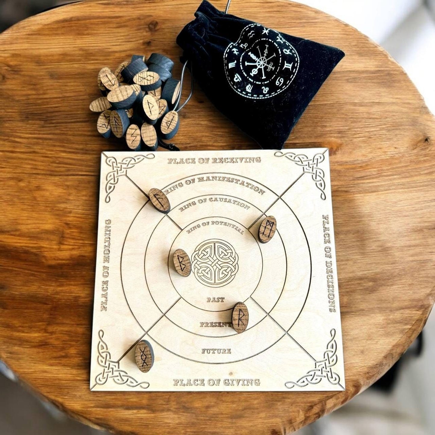 a wooden board game with a black bag and wooden tokens on a wooden table.