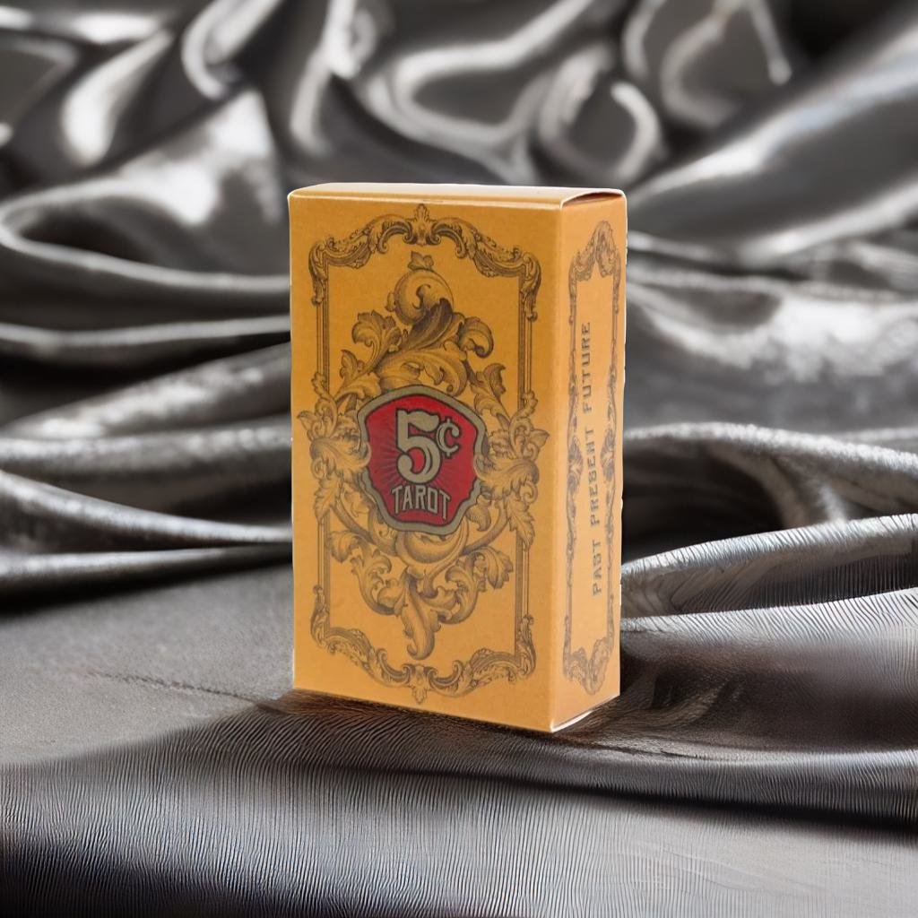 A yellow tarot card box with a gold and red design, featuring the text "5c" and "TAROT" on the front.