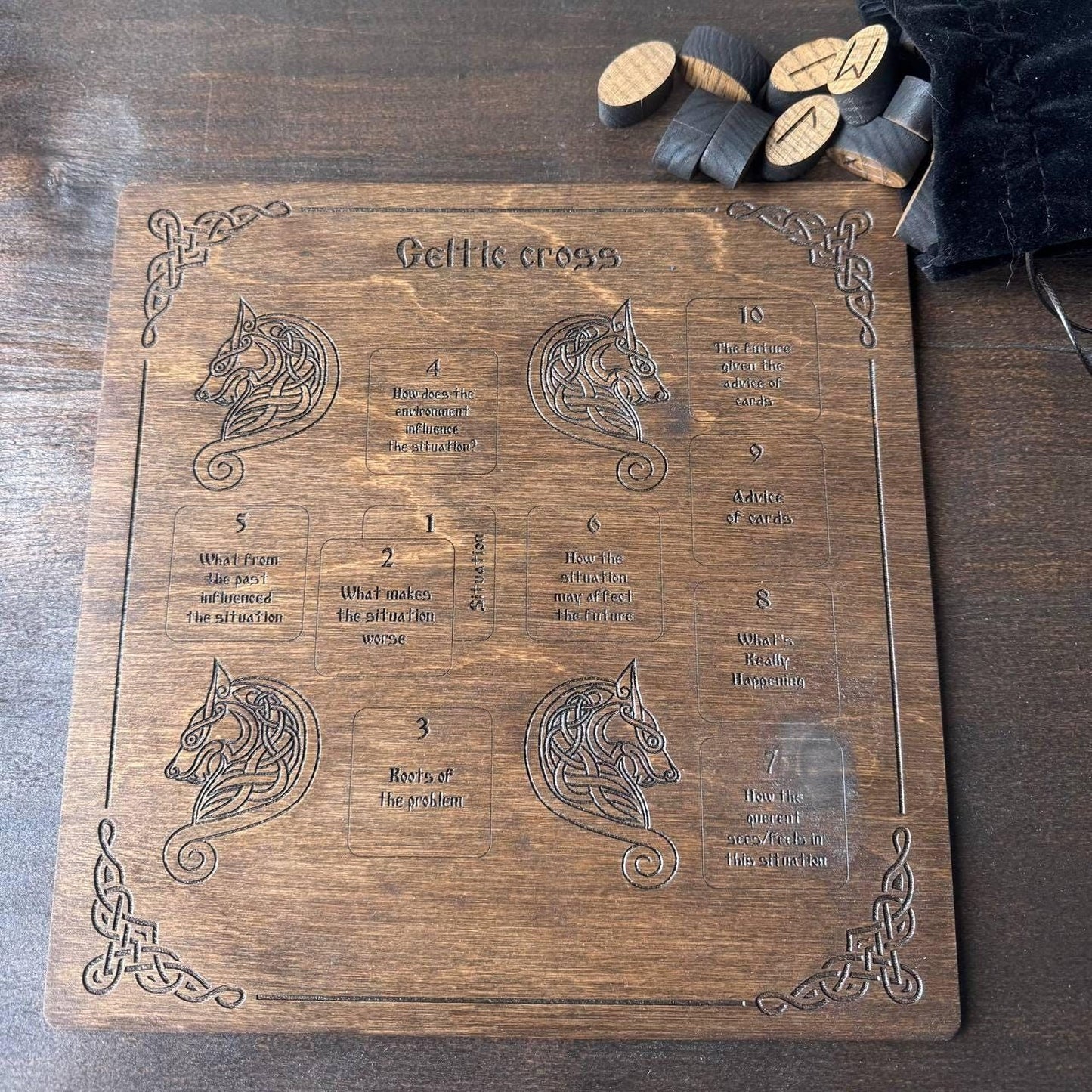 a wooden board with a Celtic cross design and some cork pieces on top.