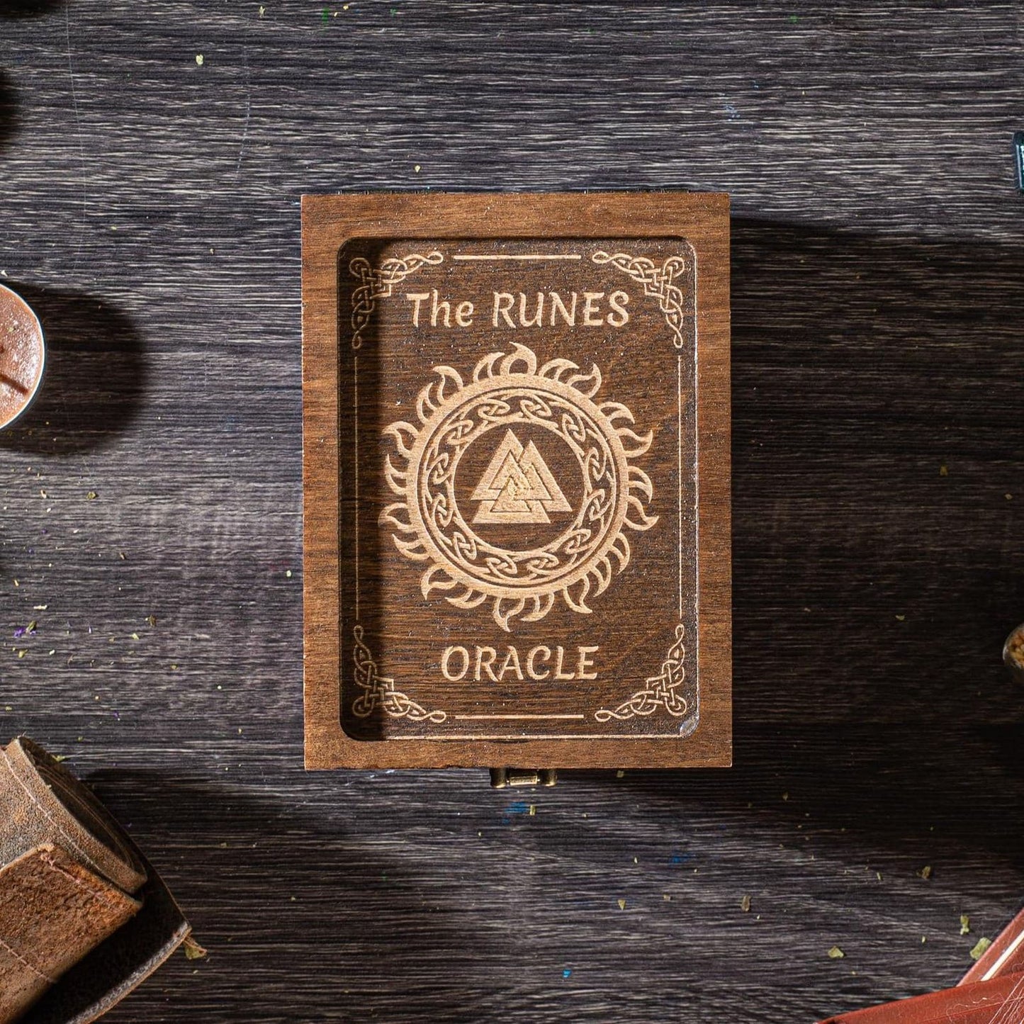 A wooden box with the text "The Ruins Oracle" engraved on it, placed on a wooden surface.