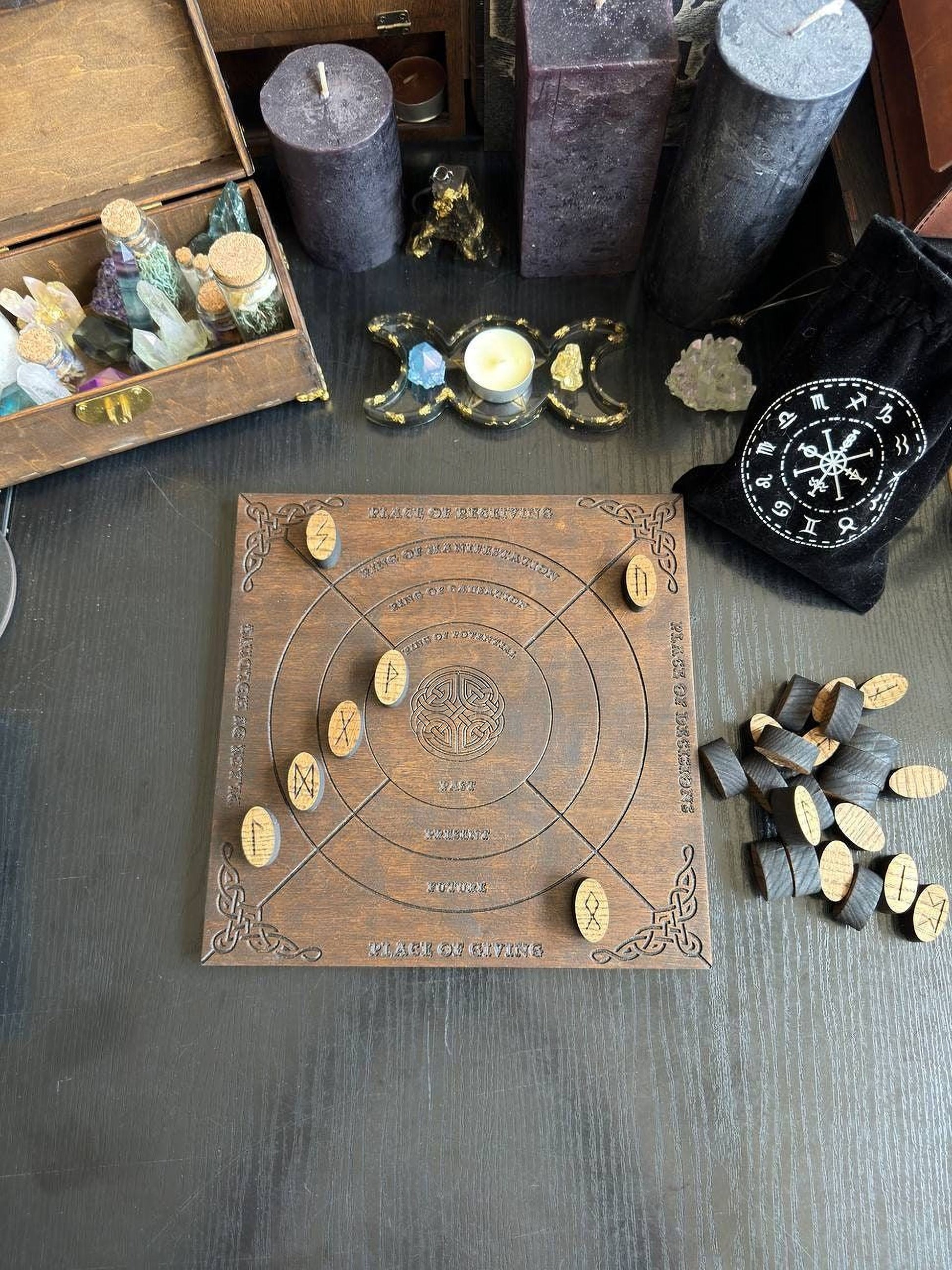 a wooden board game with various objects and symbols on it, including a clock, candles, and other items, all arranged on a wooden surface.
