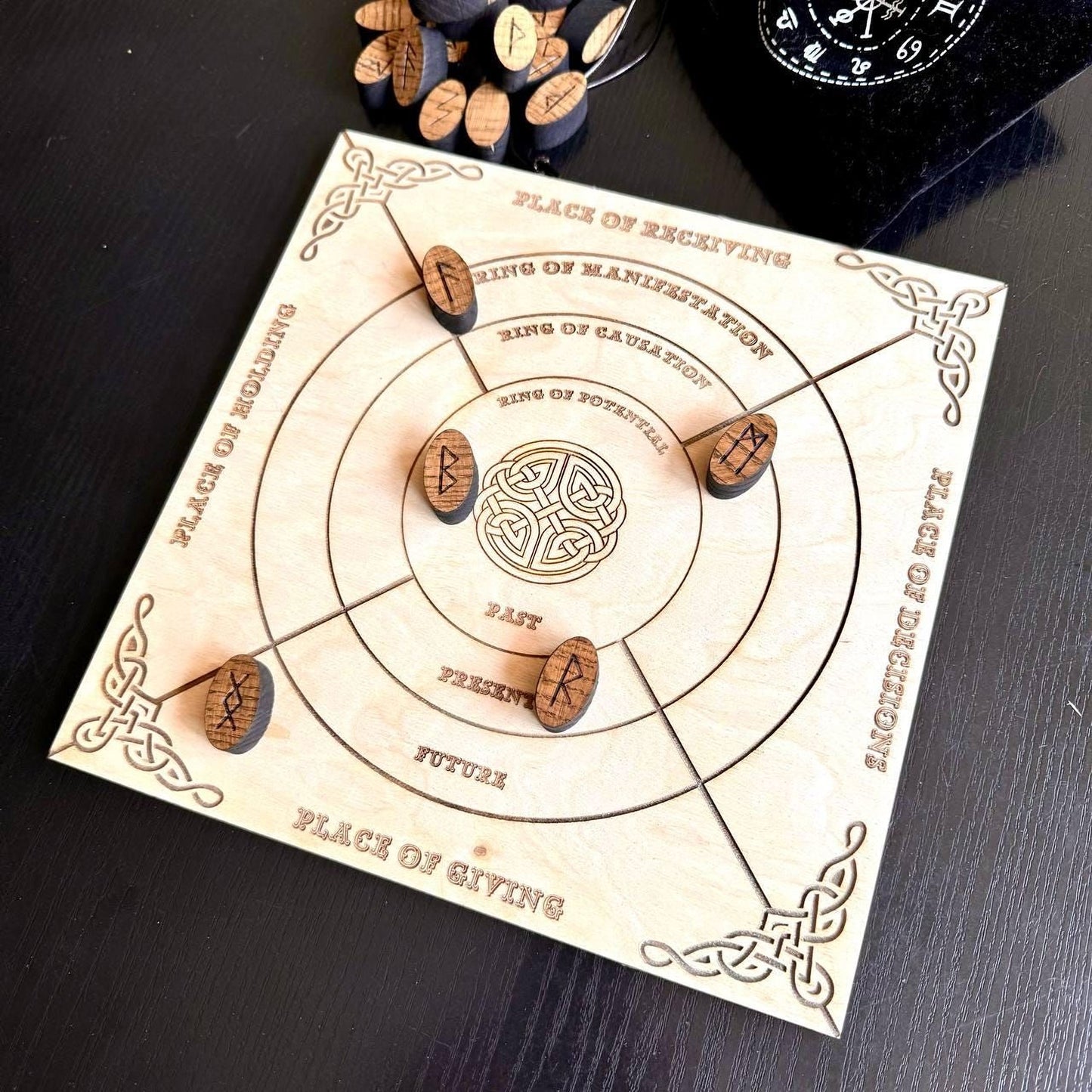 a wooden board game with a circular design and wooden pieces, placed on a dark surface.