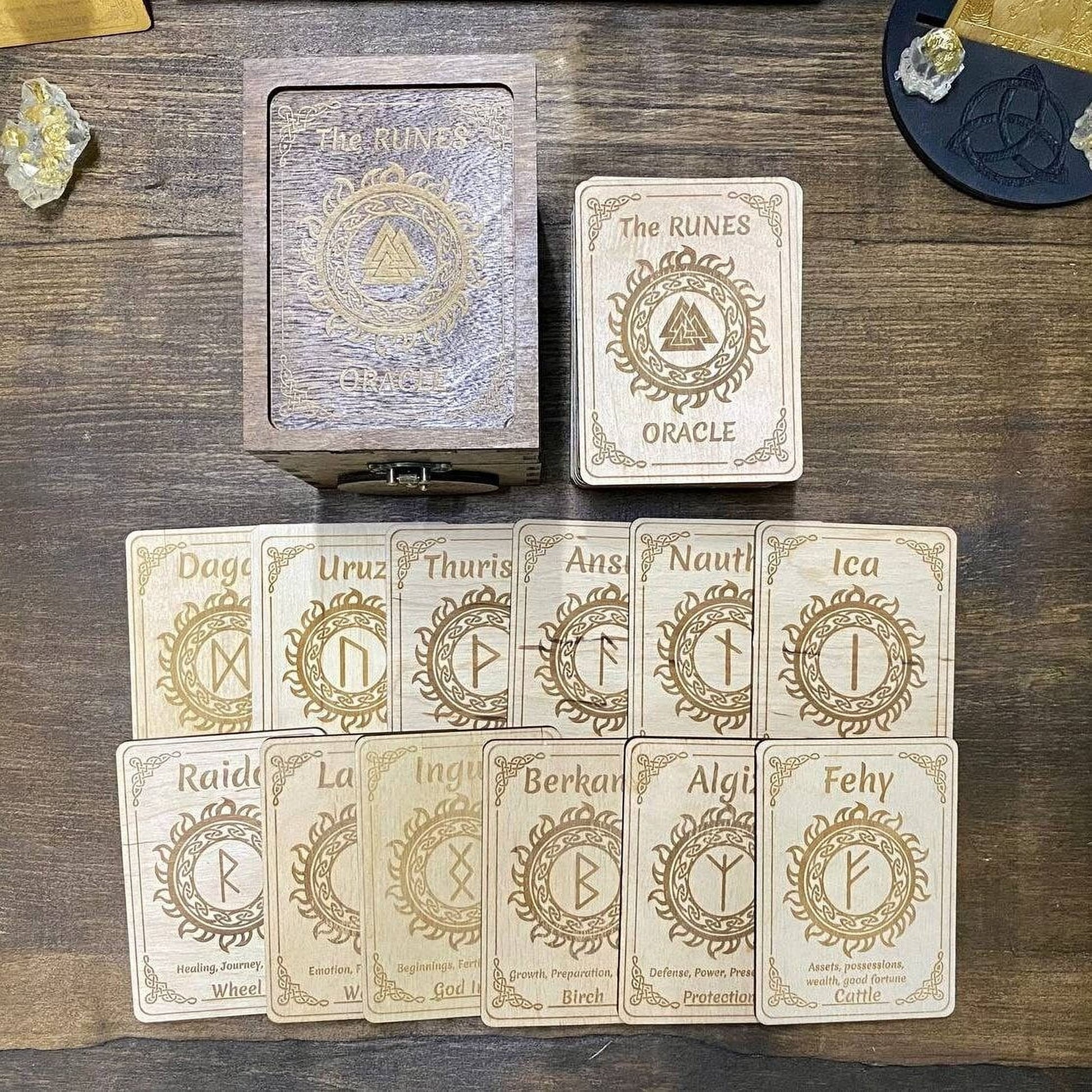 a collection of wooden cards with various symbols and text, likely representing the Oracle card set from the "The Runes" series.