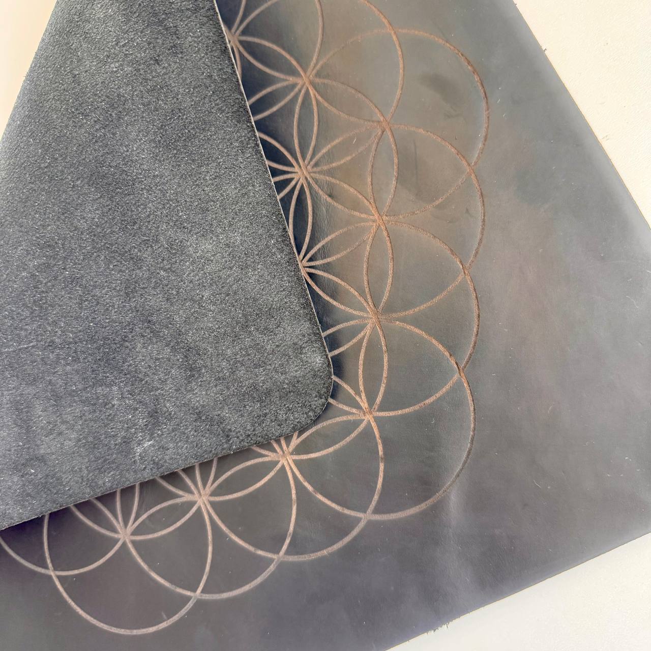 a close-up view of a black and gray patterned surface with a circular design.