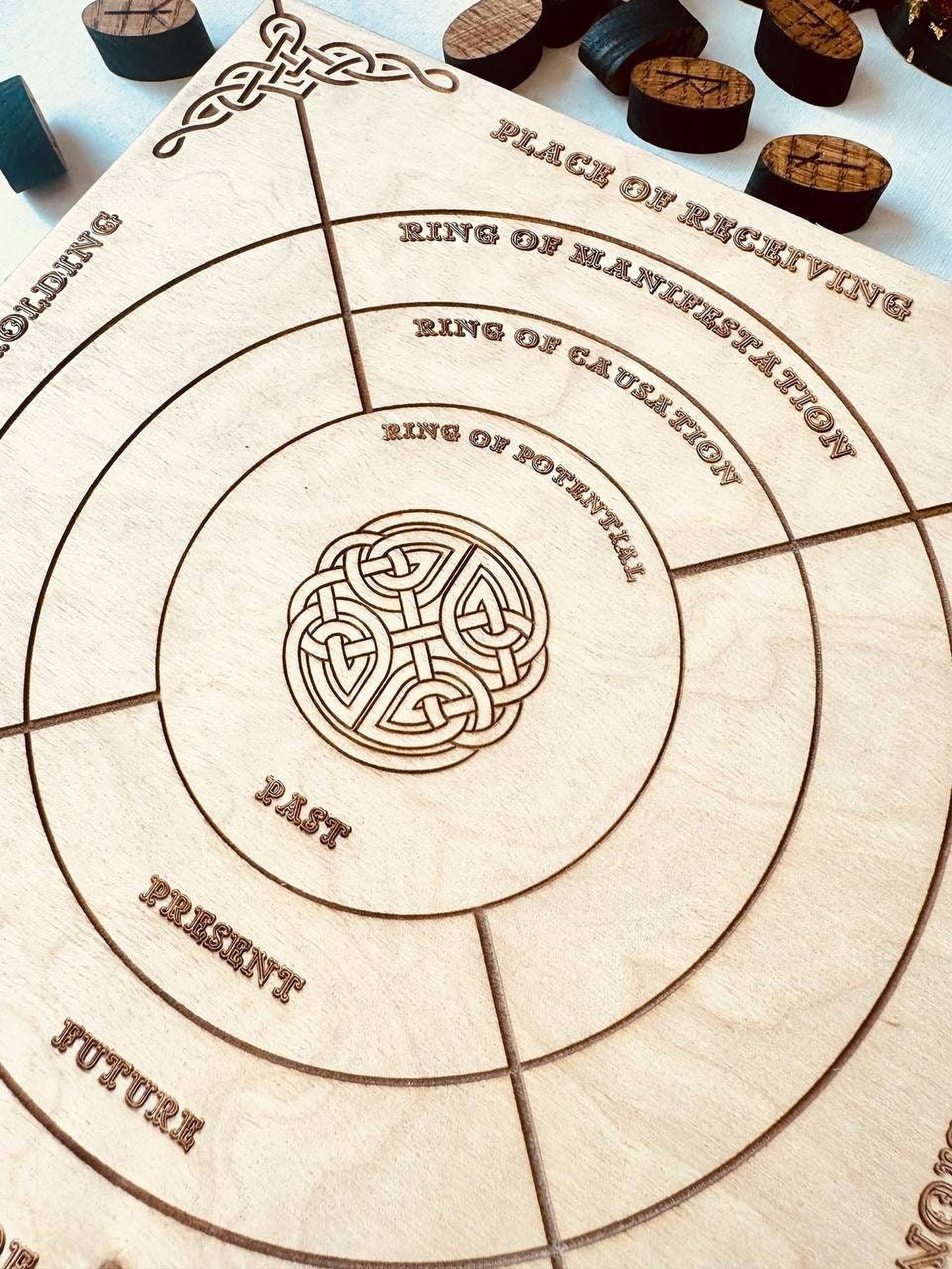 a wooden board with concentric circles and a central design element, possibly a symbol or pattern.