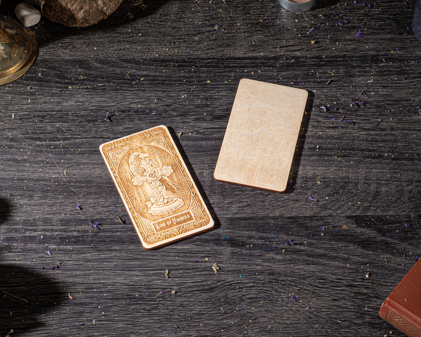 a wooden card with an embossed design, placed on a wooden surface with scattered wood shavings around it.