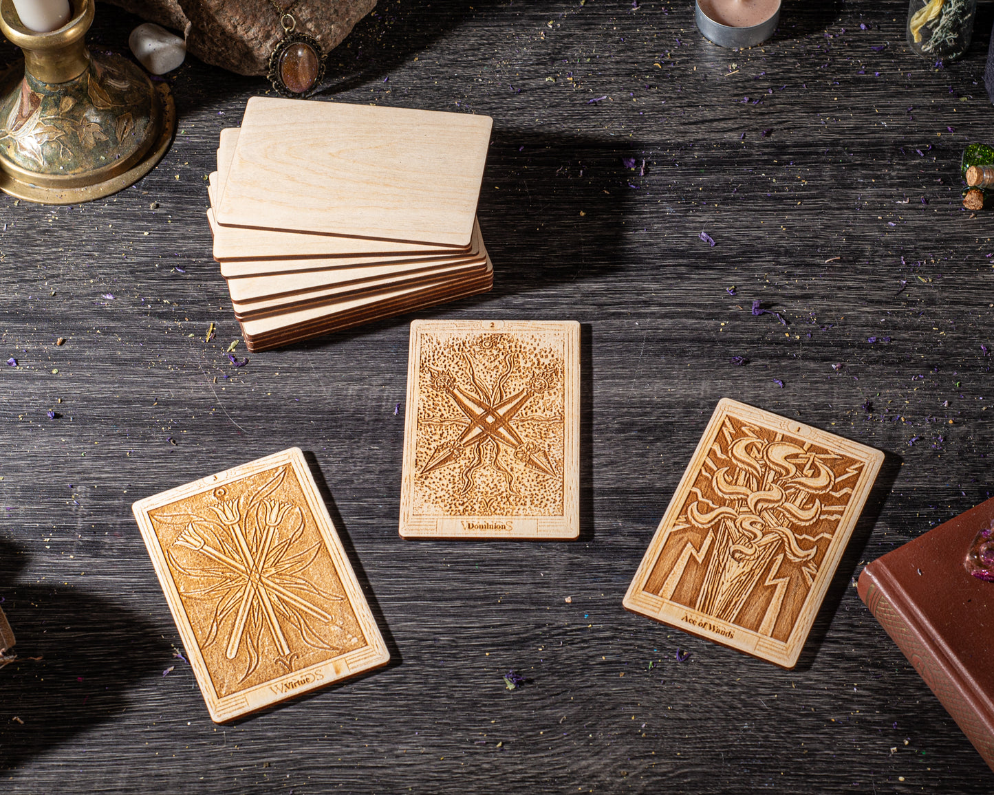 three wooden tarot cards with intricate designs, placed on a dark wooden surface.