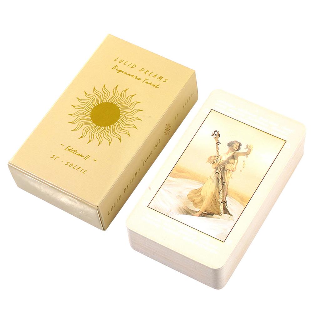 a tan-colored box with a gold sun design and text, and a white-colored card featuring an illustration of a woman.