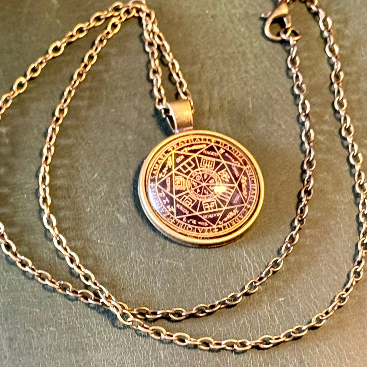 A necklace with a circular pendant featuring an intricate design.