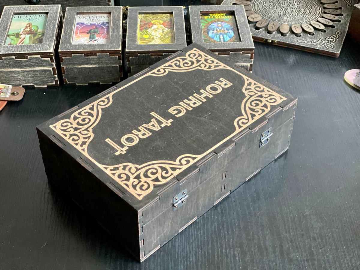 A wooden box with the text "Rothcraft" on it, sitting on a table surrounded by other items.