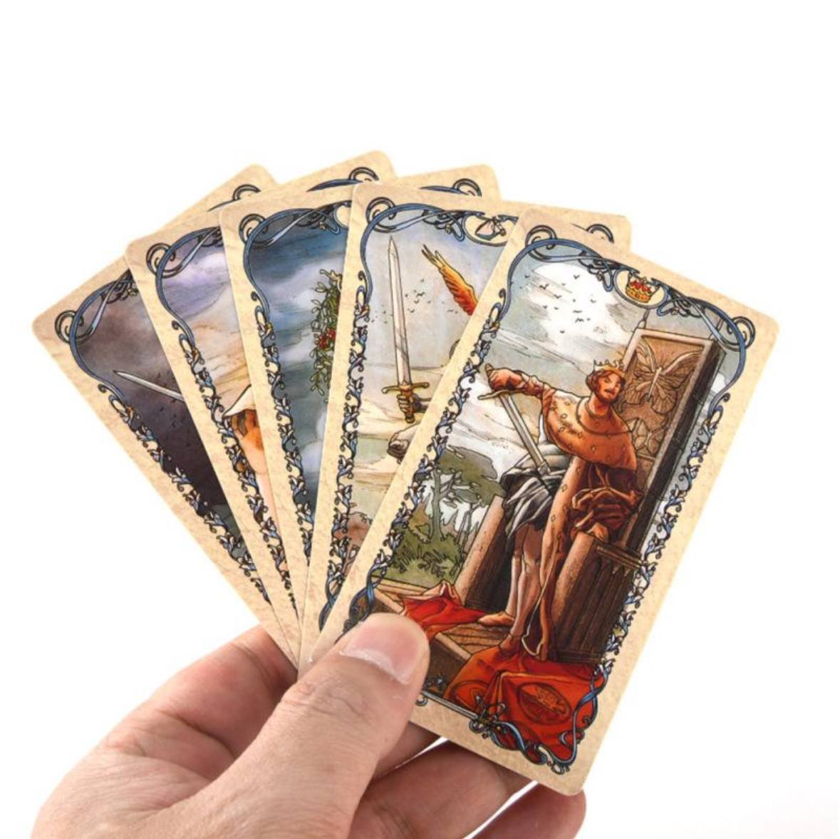 A hand holding a deck of playing cards with various illustrations on the front.
