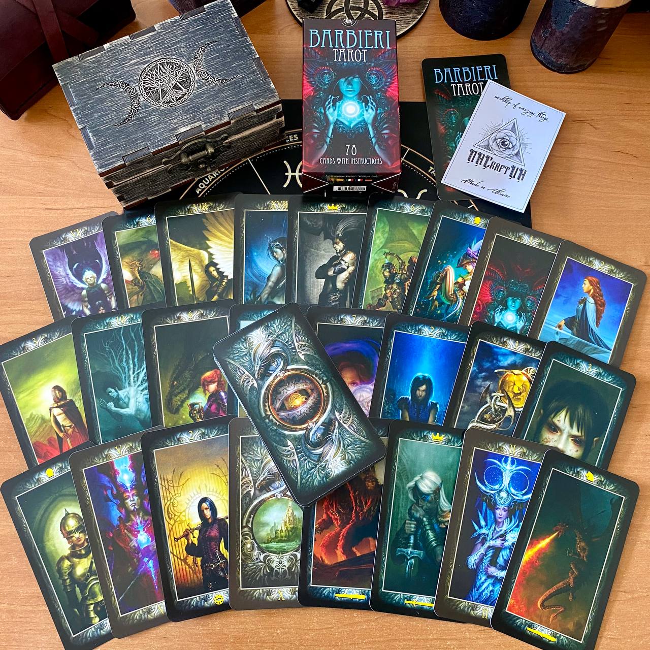 a collection of tarot cards and a wooden box, likely used for fortune-telling or divination purposes.