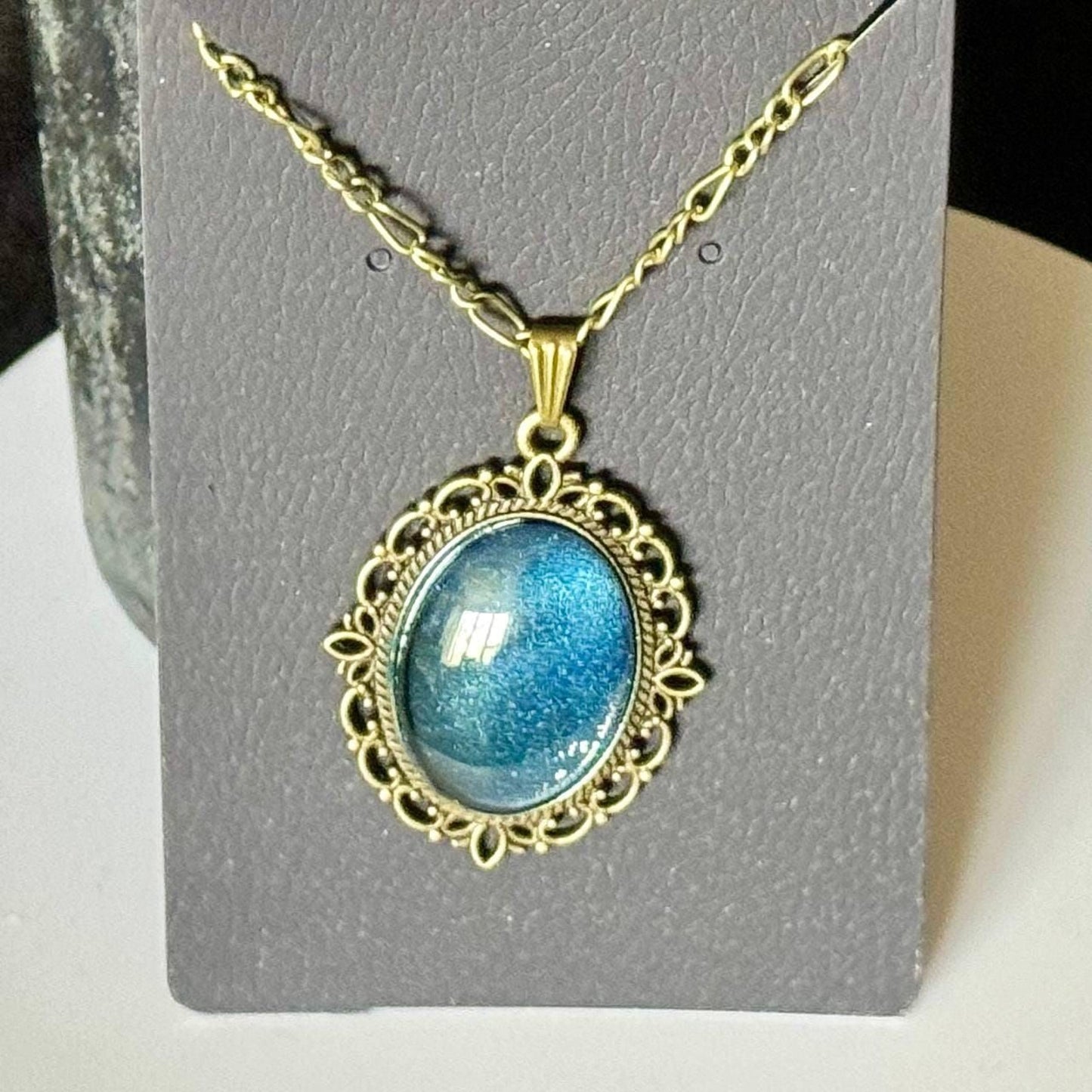 A necklace with a large, blue gemstone pendant, which appears to be a piece of jewelry.