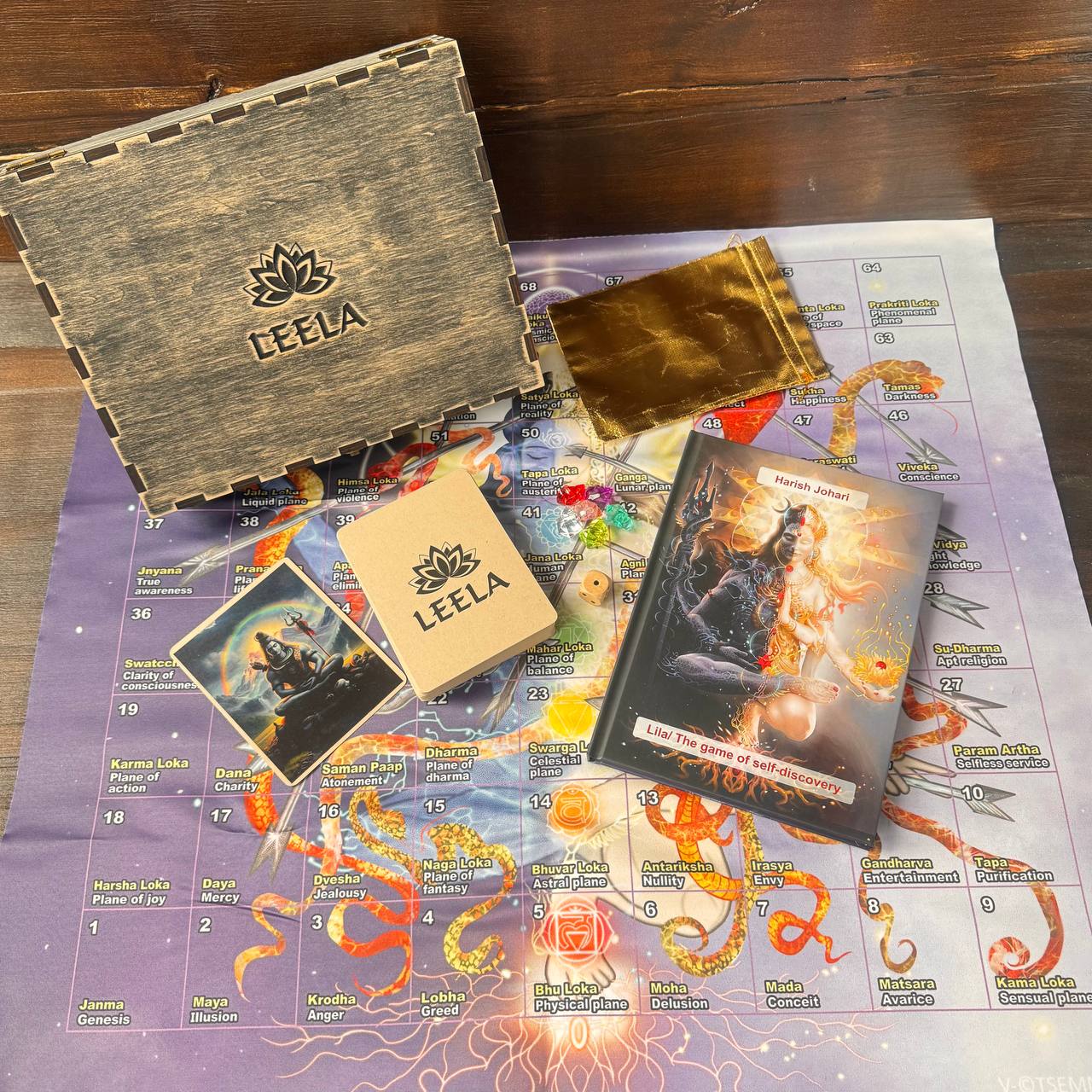 a wooden box, a book, and a map, all of which are related to the game "Leela".
