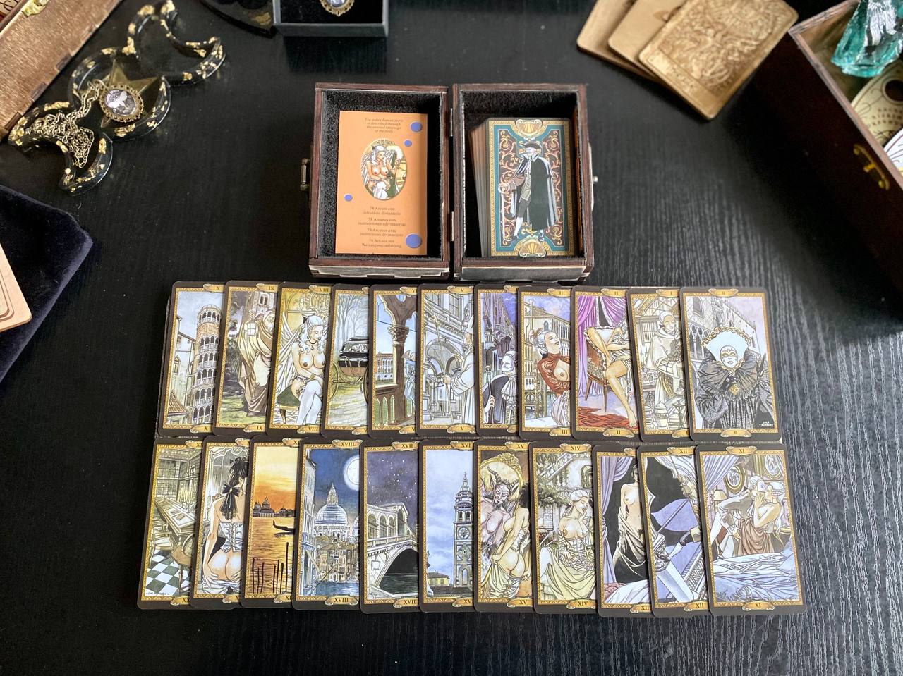 a collection of tarot cards arranged on a table, with some cards placed in boxes.