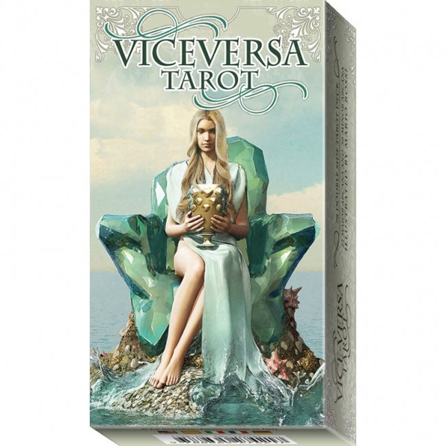 The image is a tarot card depicting a woman sitting on a rock with a crystal-like gemstone in her hand.