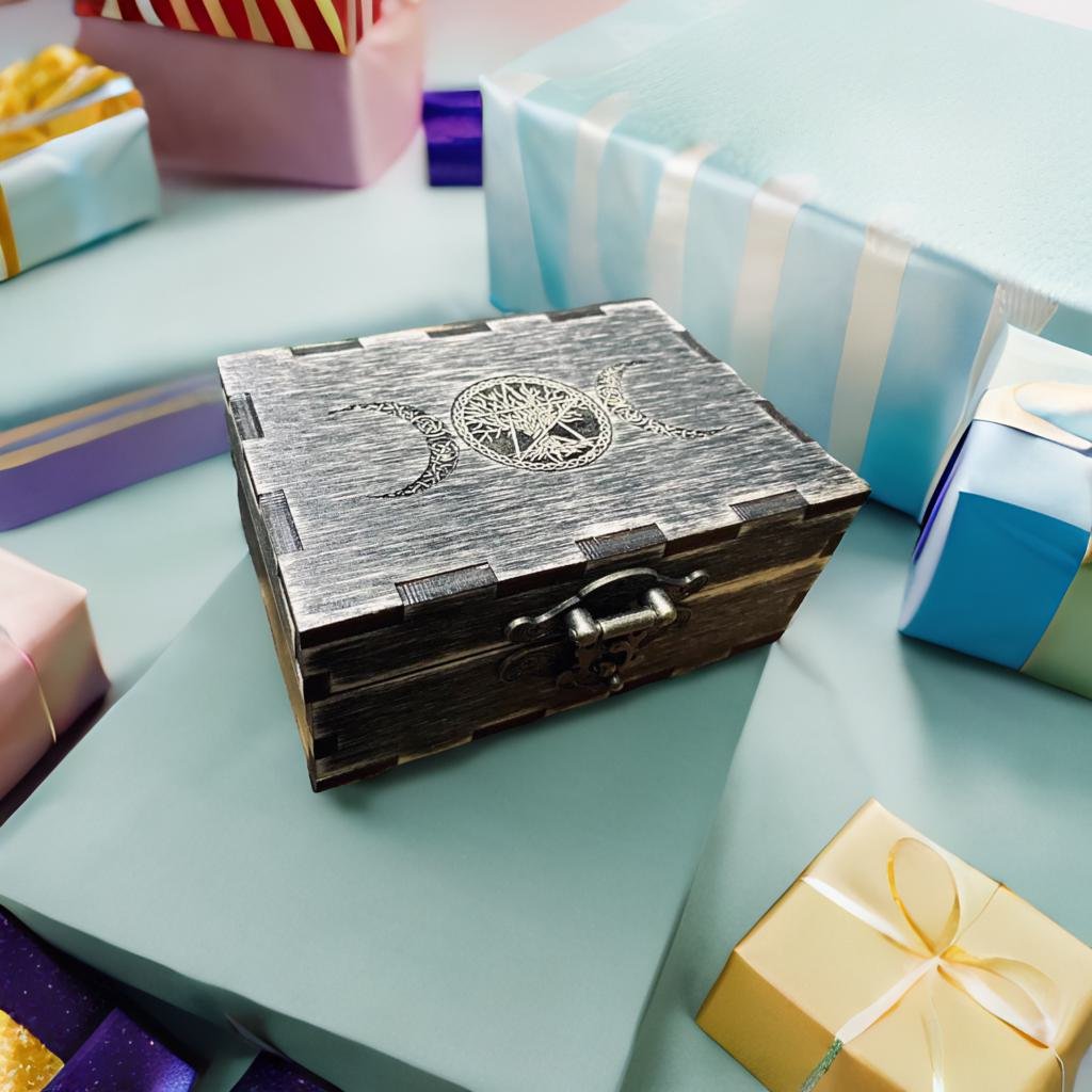 A wooden box with a metal clasp sits on a light blue surface, surrounded by various wrapped gifts and presents.
