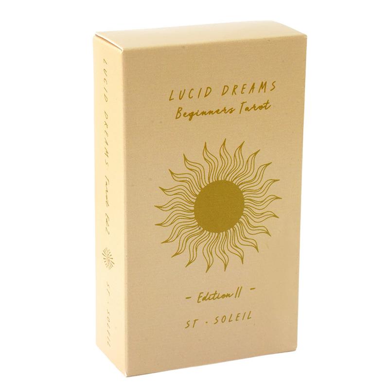 The image is a cardboard box for a Lucid Dreams Beginners Tarot deck, featuring a sun design and text indicating the edition and publisher.