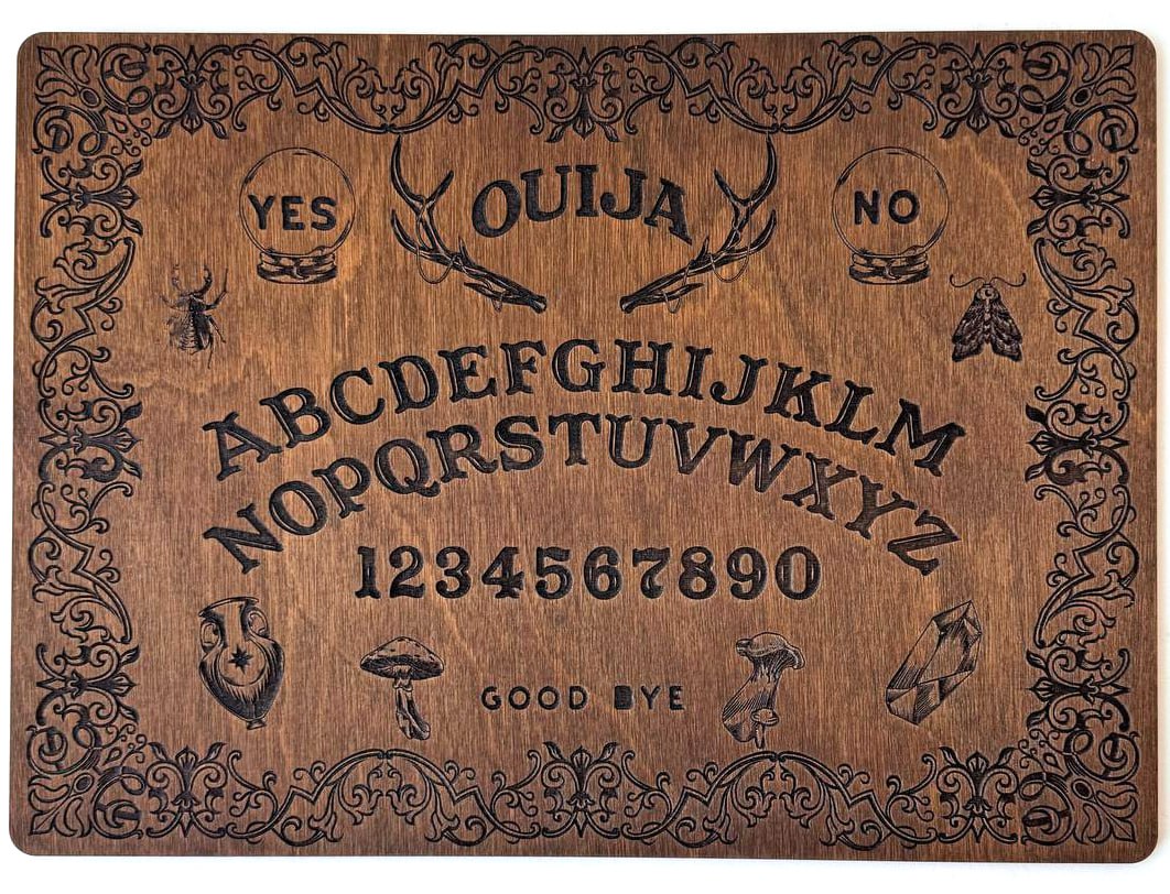 The image is a wooden Ouija board with a decorative border and various symbols and text.