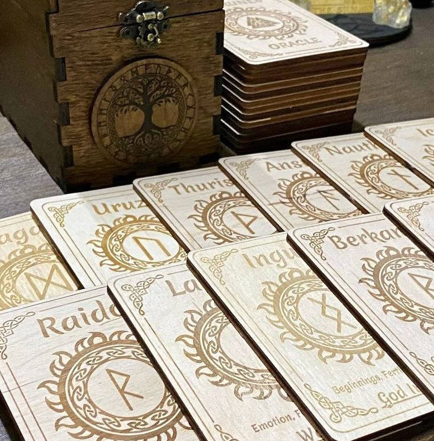 a collection of wooden cards with intricate designs and text, arranged on a wooden surface.