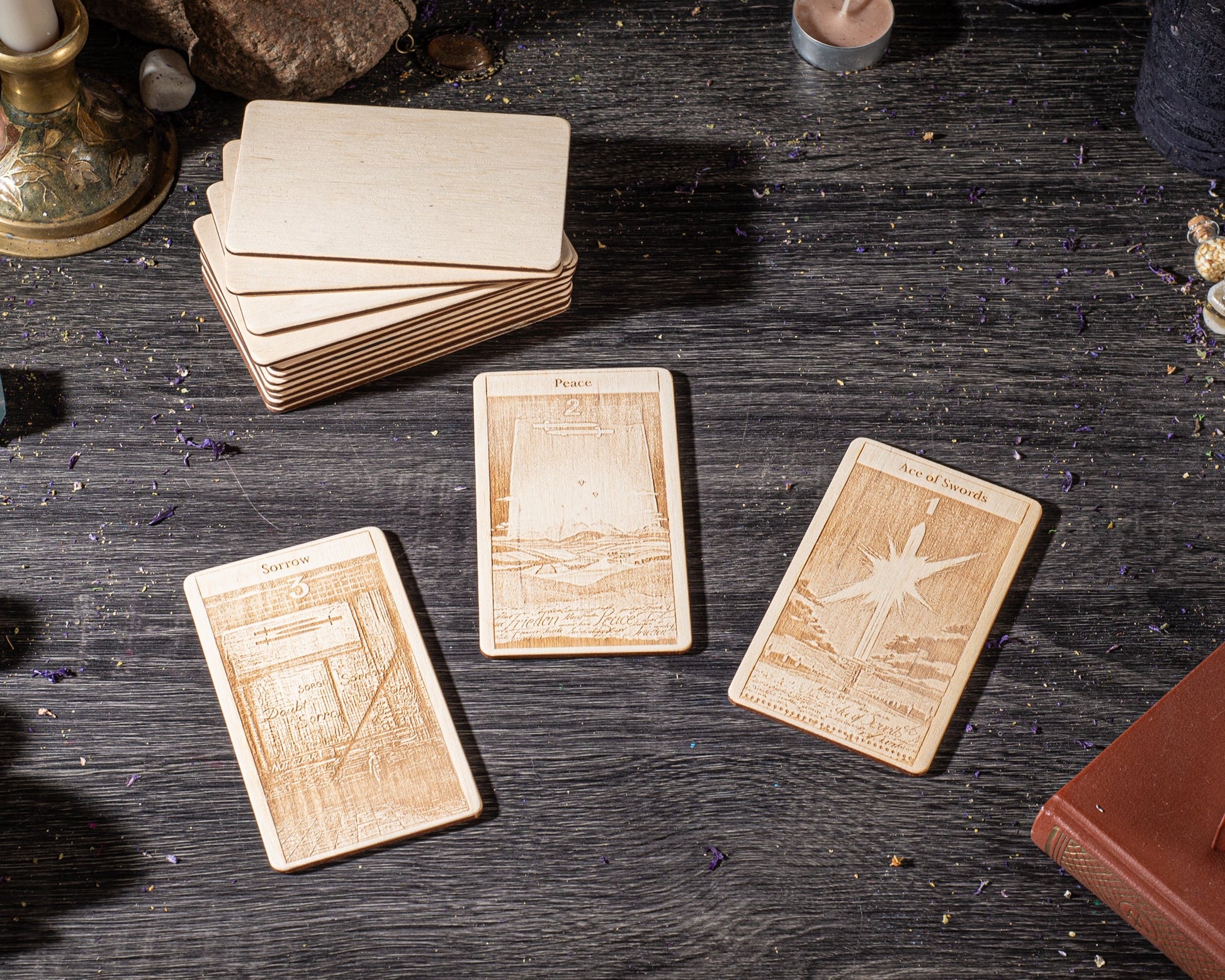 three wooden cards with different designs, placed on a wooden surface.